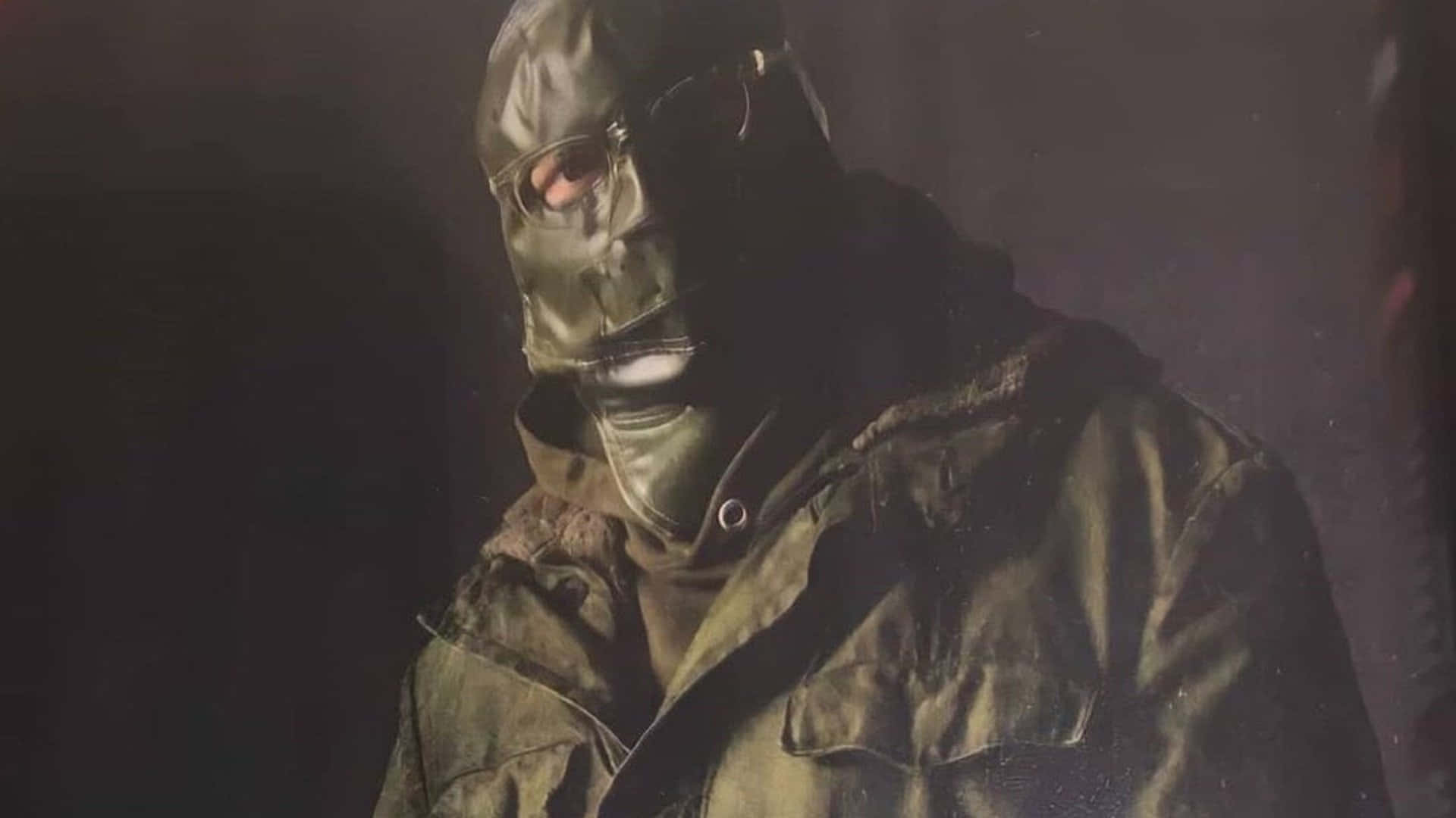 A Man In A Green Jacket And A Mask Background