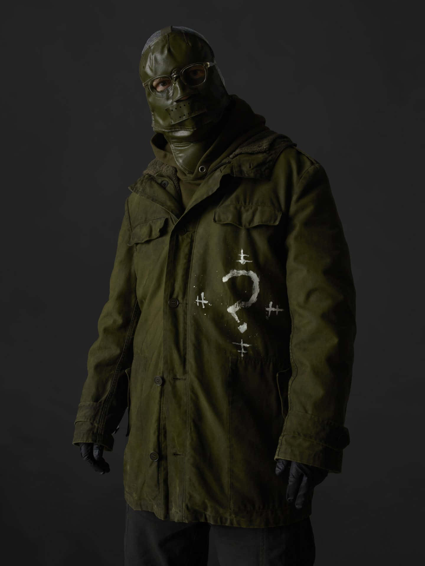 A Man In A Green Jacket And A Mask Background