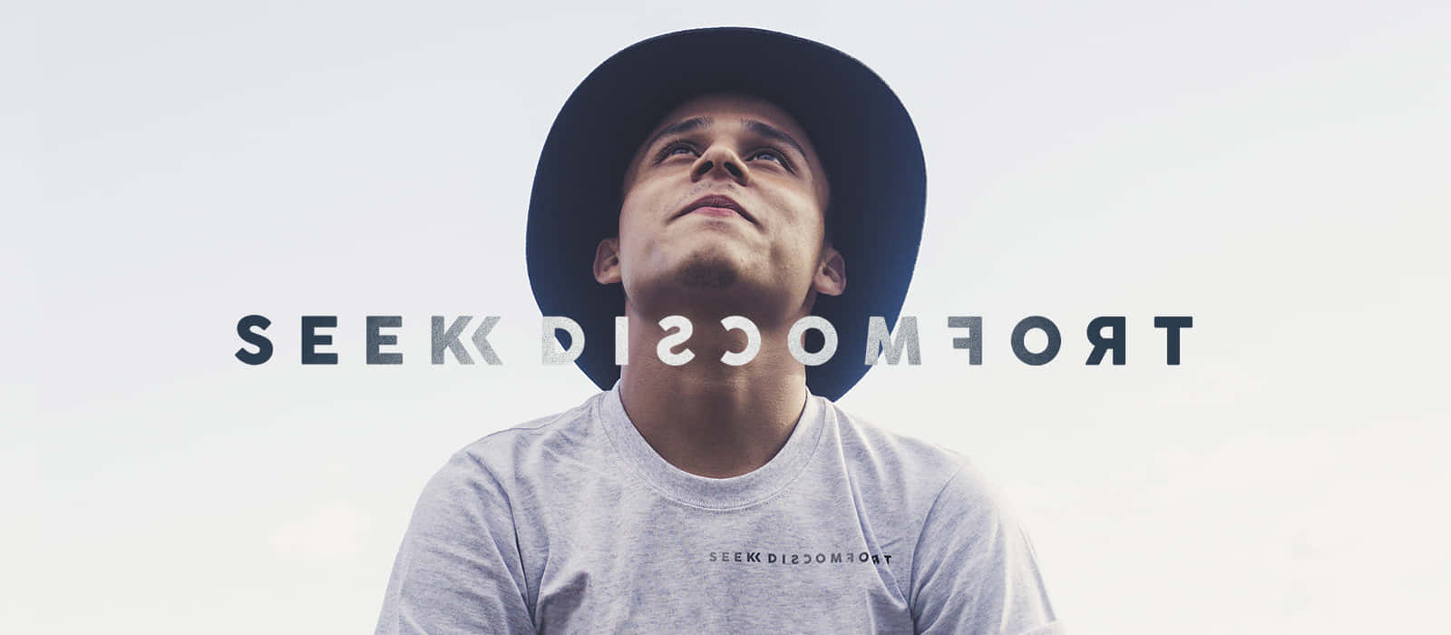 A Man In A Hat With The Words Trocco See Background