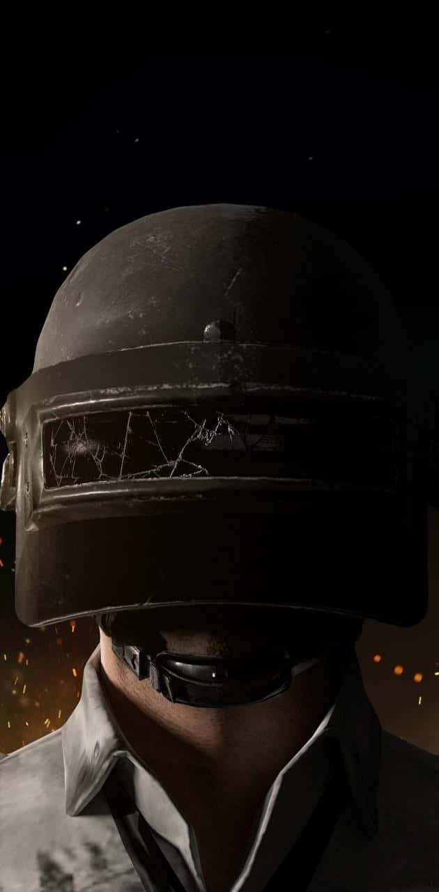 A Man In A Helmet With A Gun Background