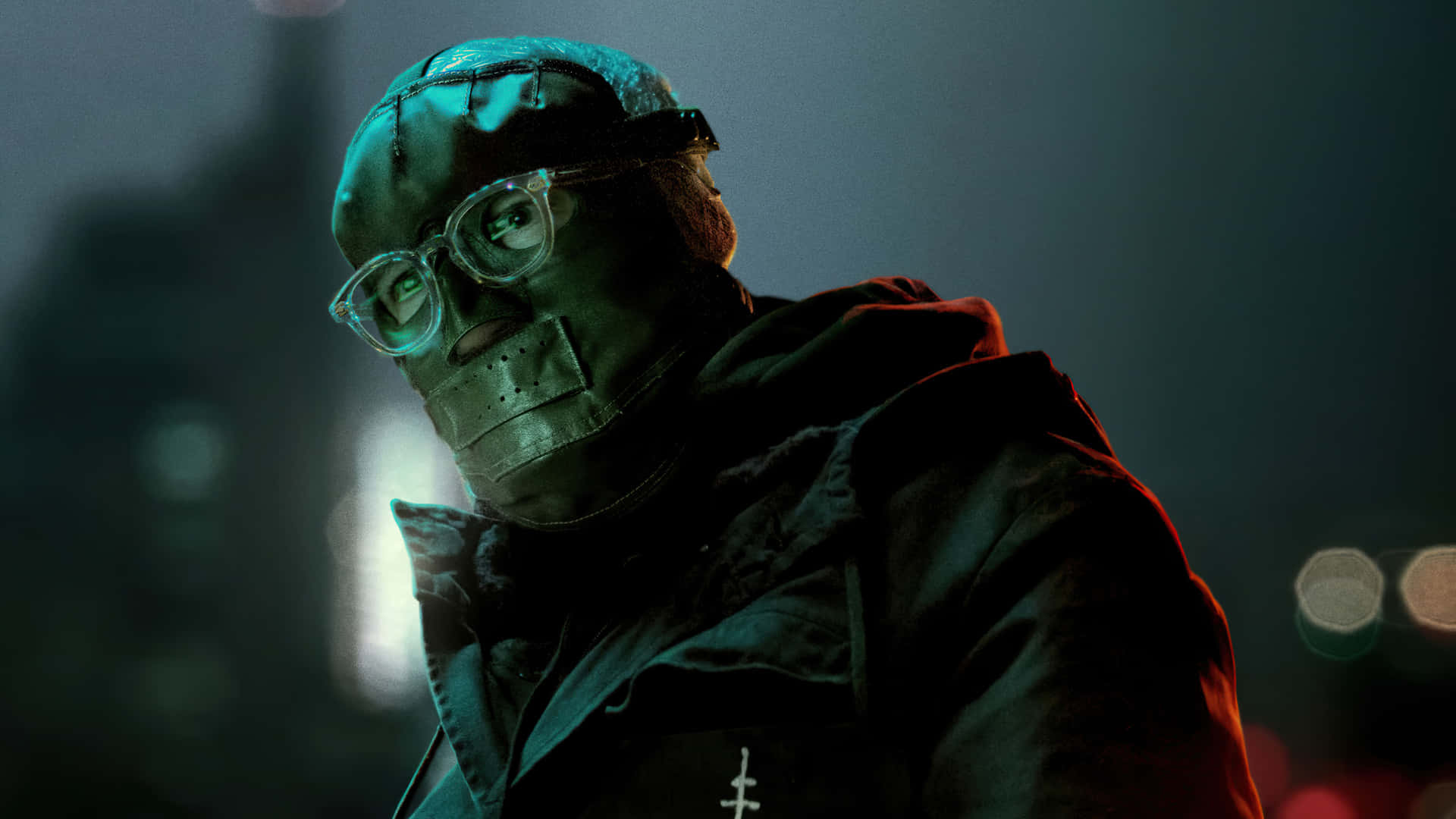 A Man In A Mask And Glasses Standing In A City Background