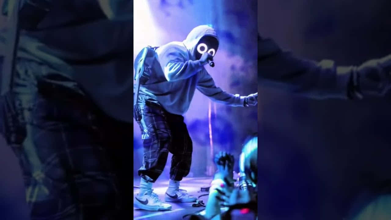 A Man In A Mask On Stage Background