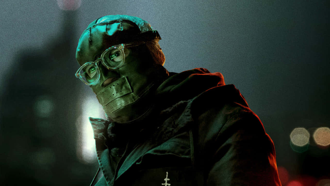 A Man In A Mask Standing In A City Background