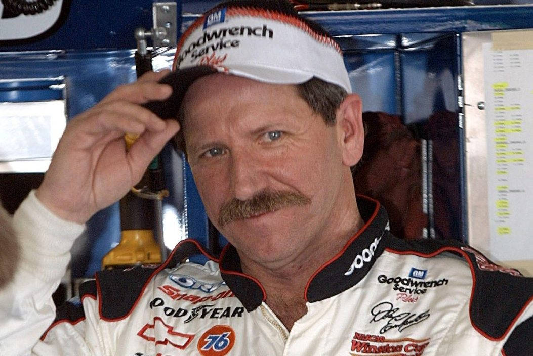 A Man In A Nascar Uniform With A Mustache