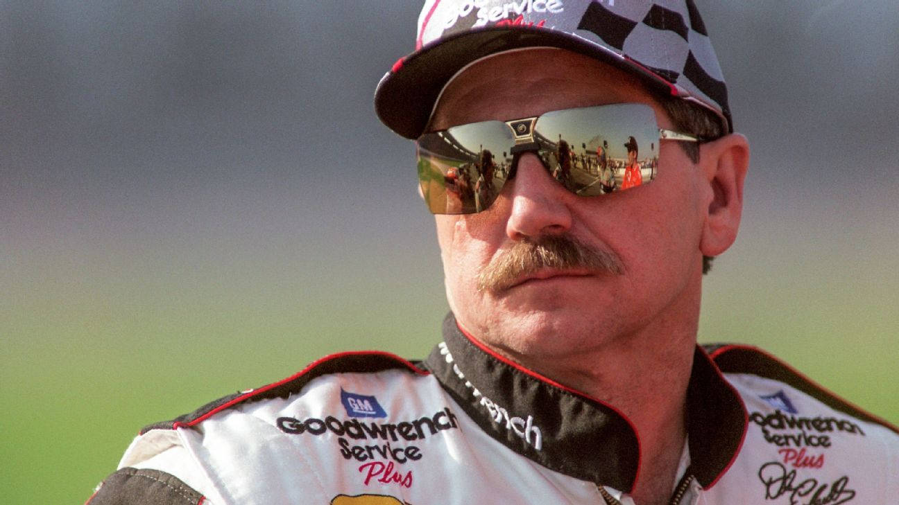 A Man In A Nascar Uniform With Sunglasses