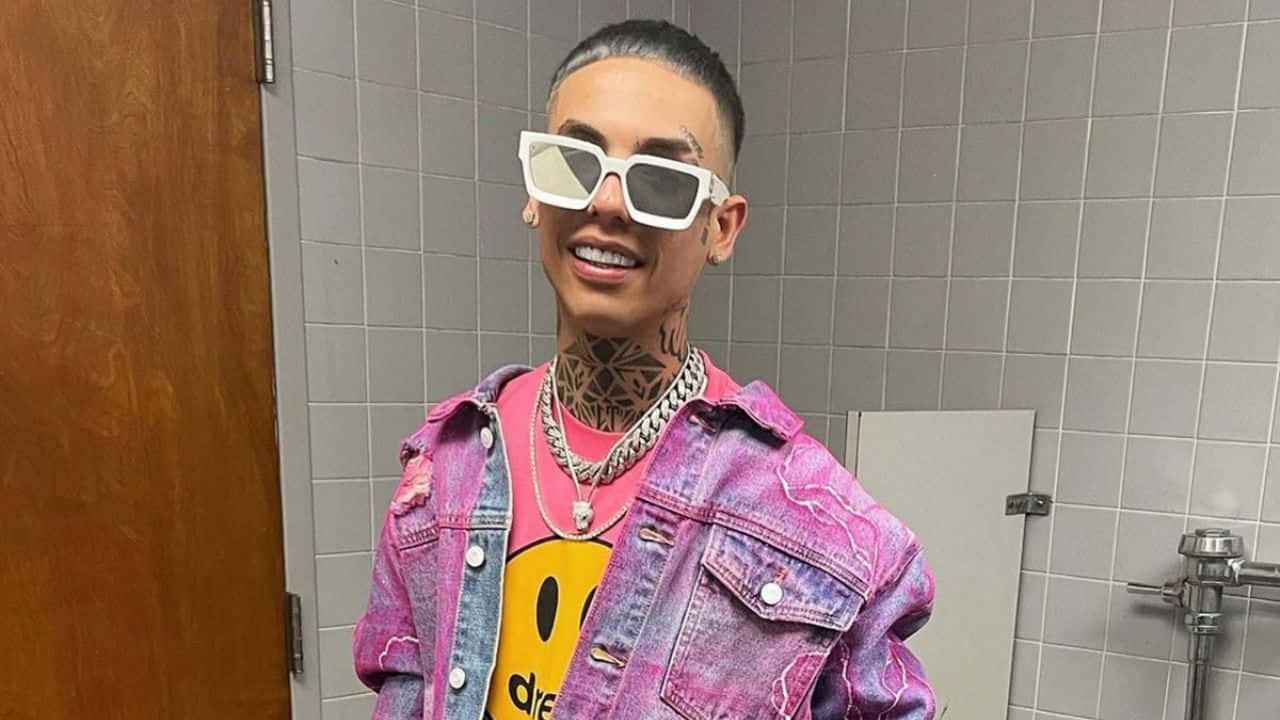 A Man In A Pink Jacket And Sunglasses Is Standing In A Bathroom Background