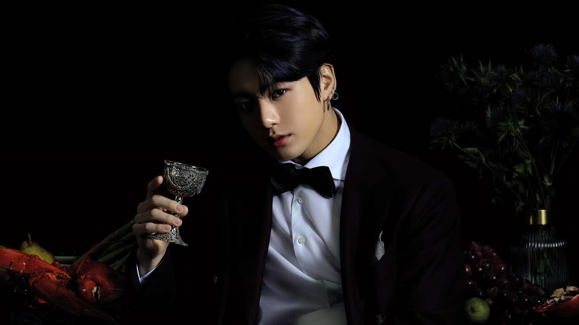 A Man In A Suit Holding A Glass Of Wine Background
