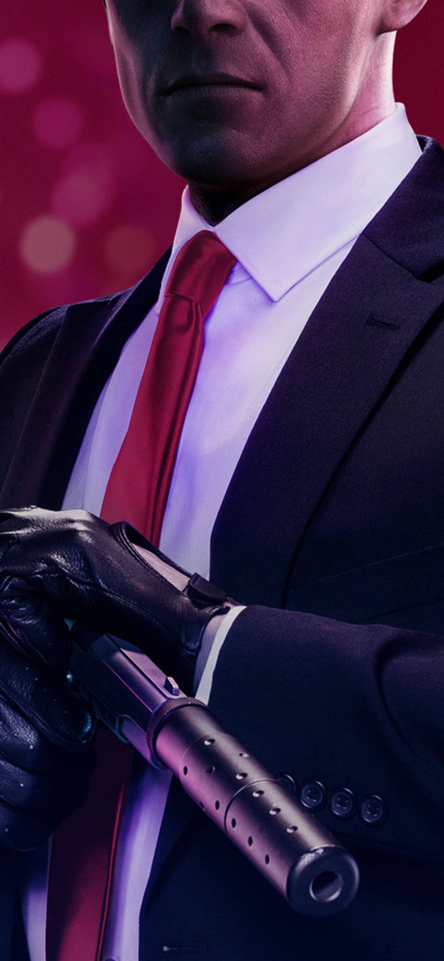 A Man In A Suit Holding A Gun Background