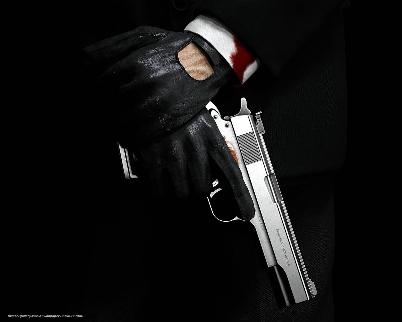 A Man In A Suit Holding A Gun Background