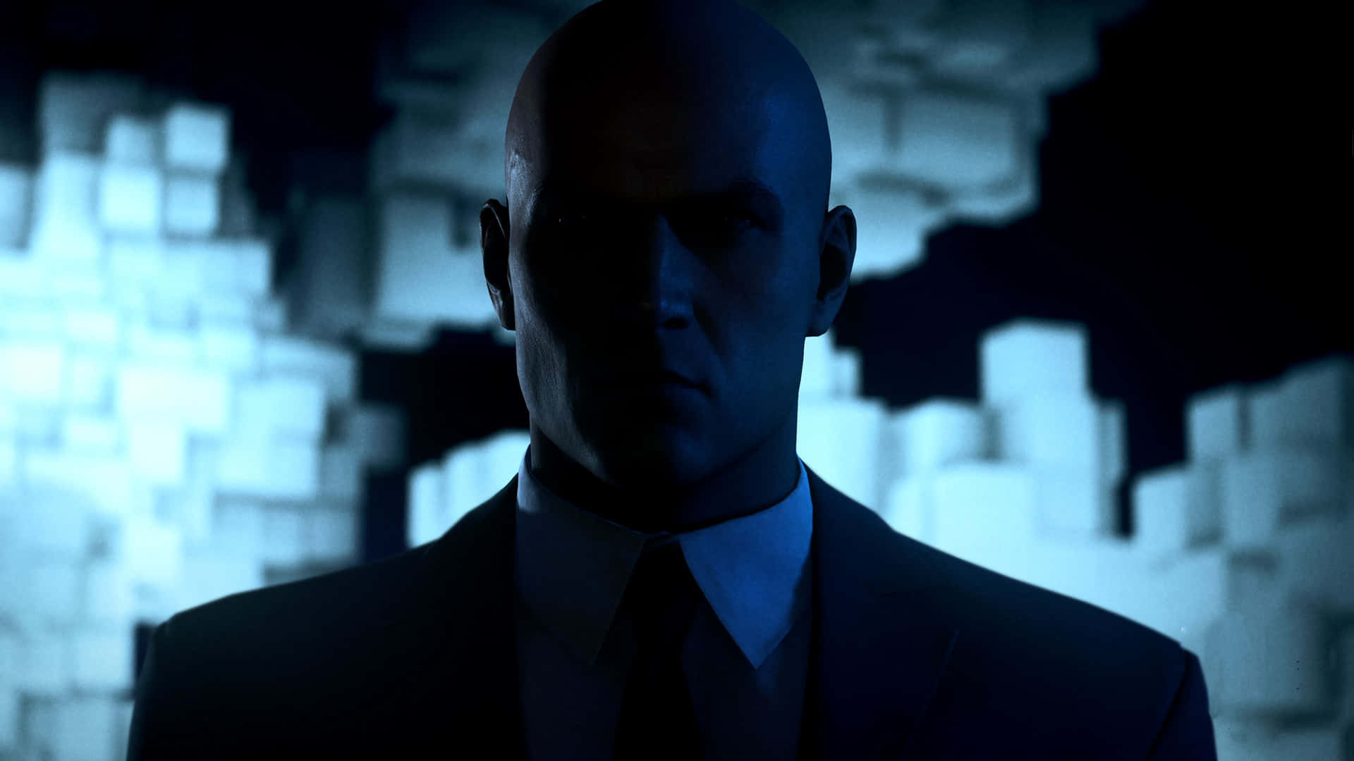 A Man In A Suit Is Standing In Front Of A Dark Background Background