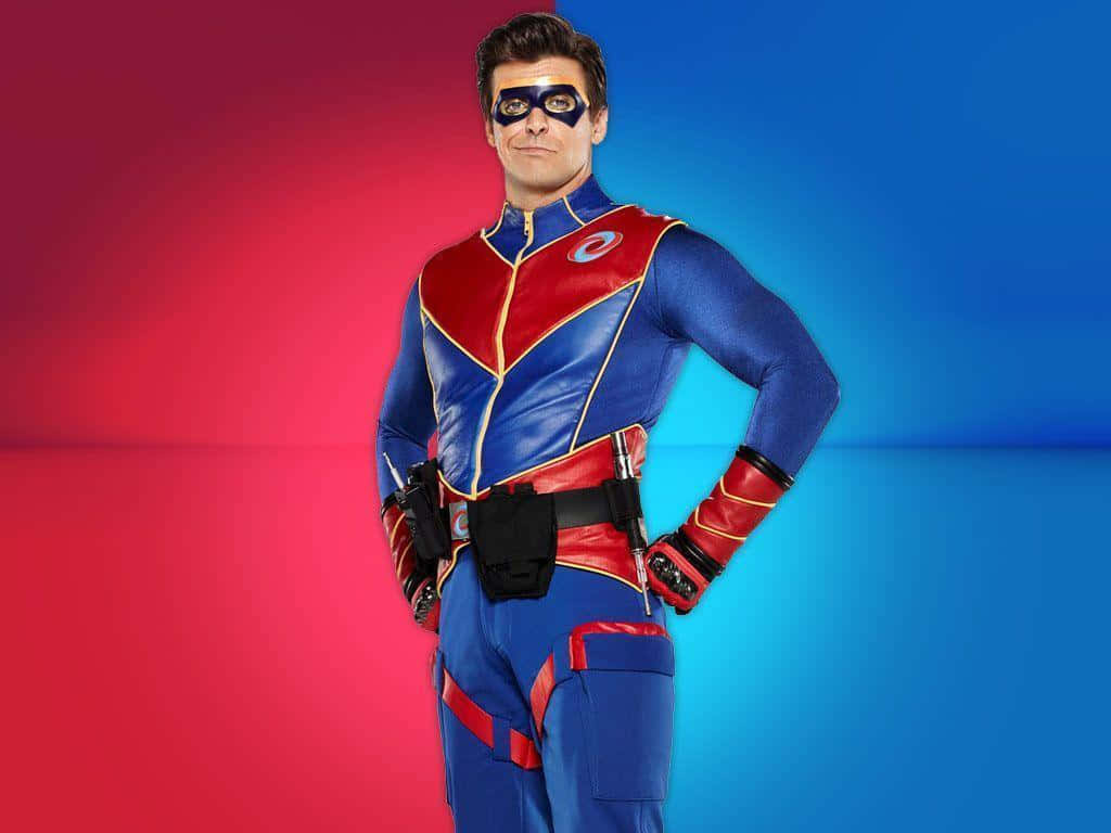 A Man In A Superhero Costume Standing In Front Of A Red And Blue Background