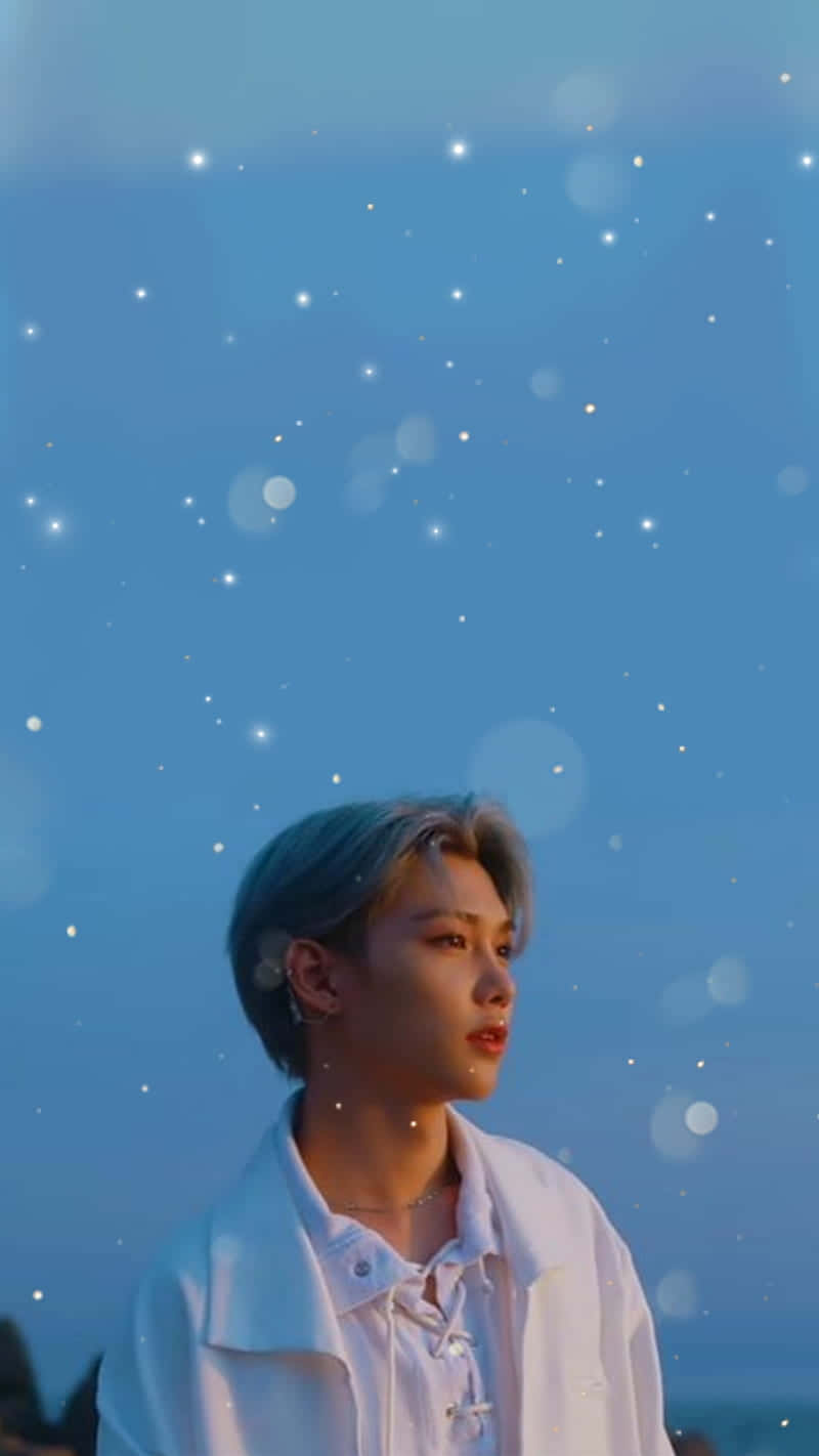 A Man In A White Jacket Standing In The Water Background