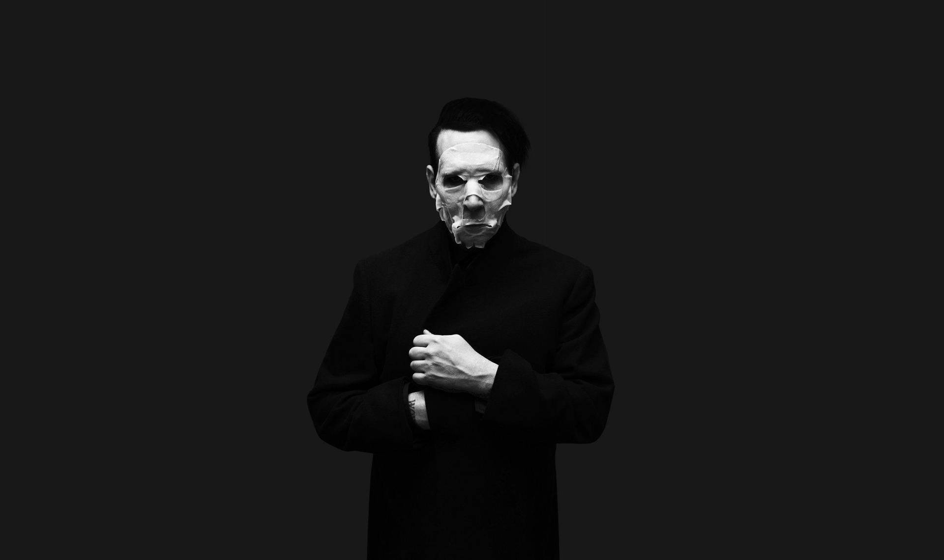 A Man In Black With A Mask On His Face Background