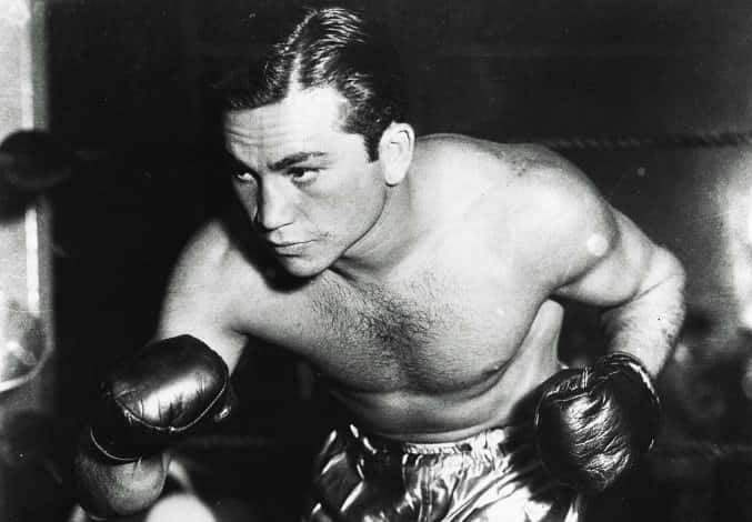 A Man In Boxing Gloves Is Posing For A Photo Background