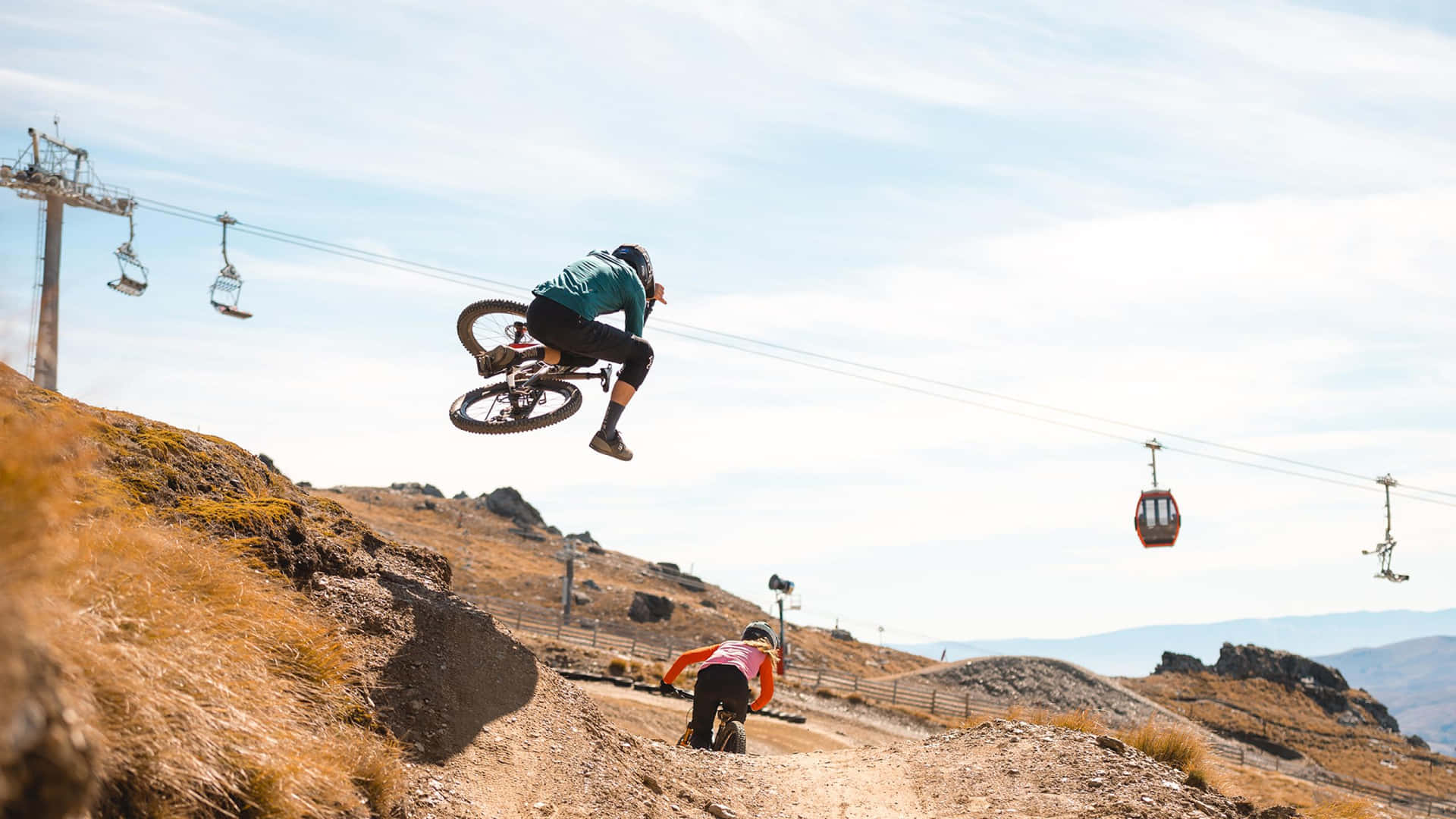 A Man Is Doing A Jump On A Mountain Bike