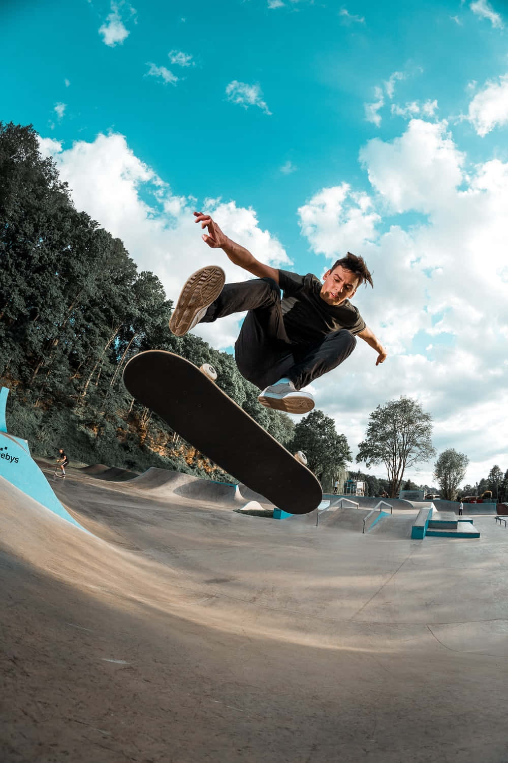 A Man Is Doing A Trick On A Skateboard Background