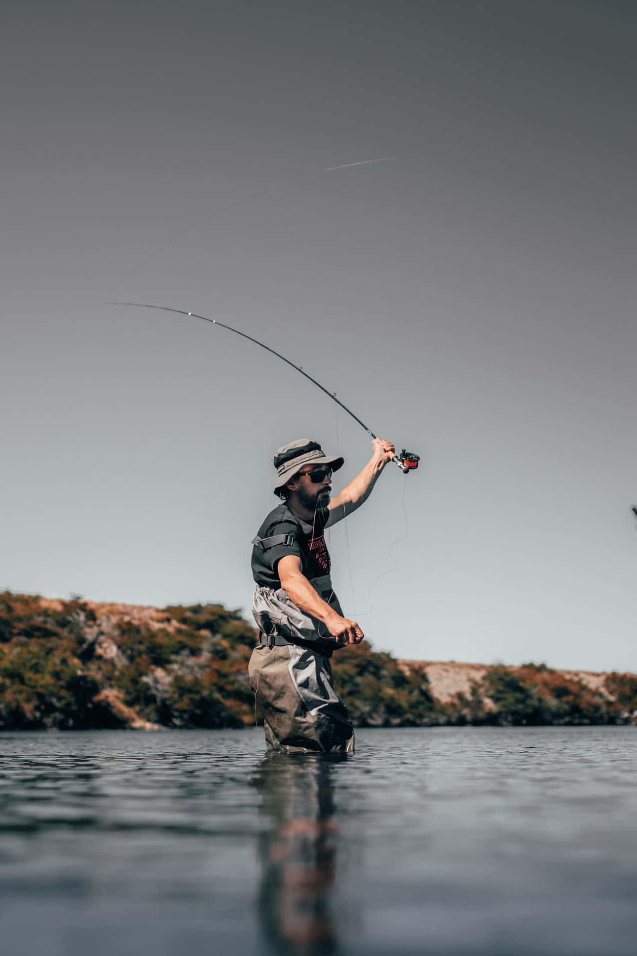 A Man Is Fly Fishing In The Water Background