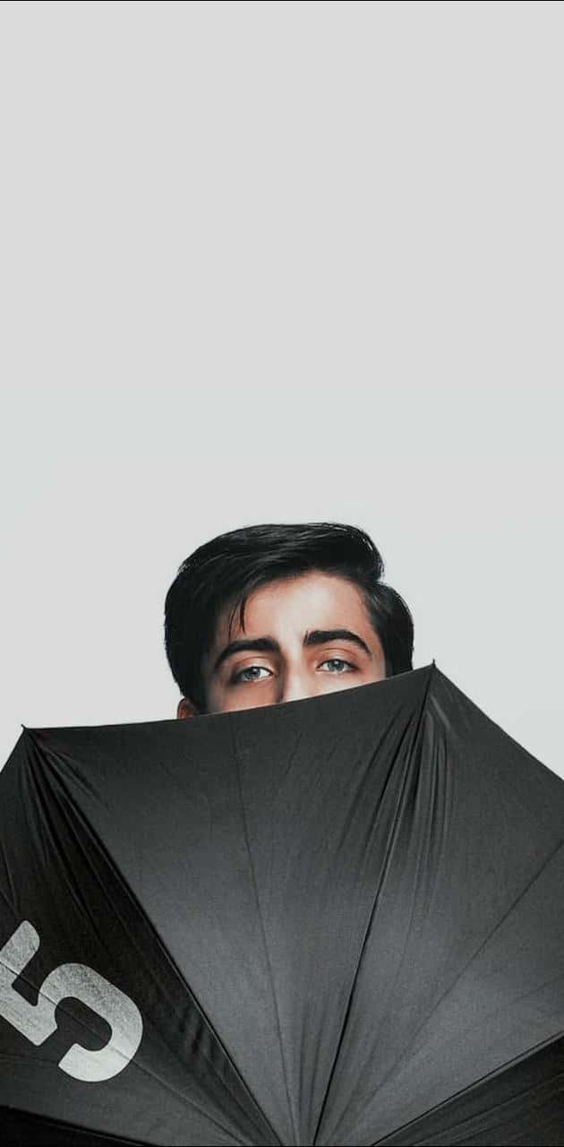 A Man Is Hiding Behind An Umbrella Background