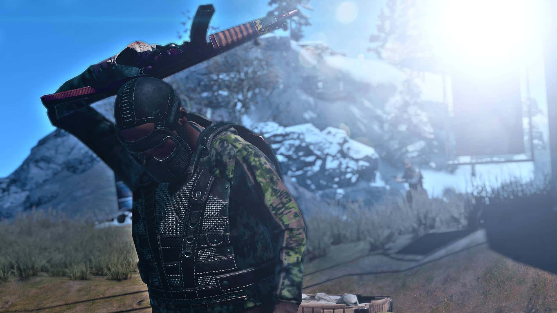 A Man Is Holding A Gun In Front Of A Snowy Mountain Background