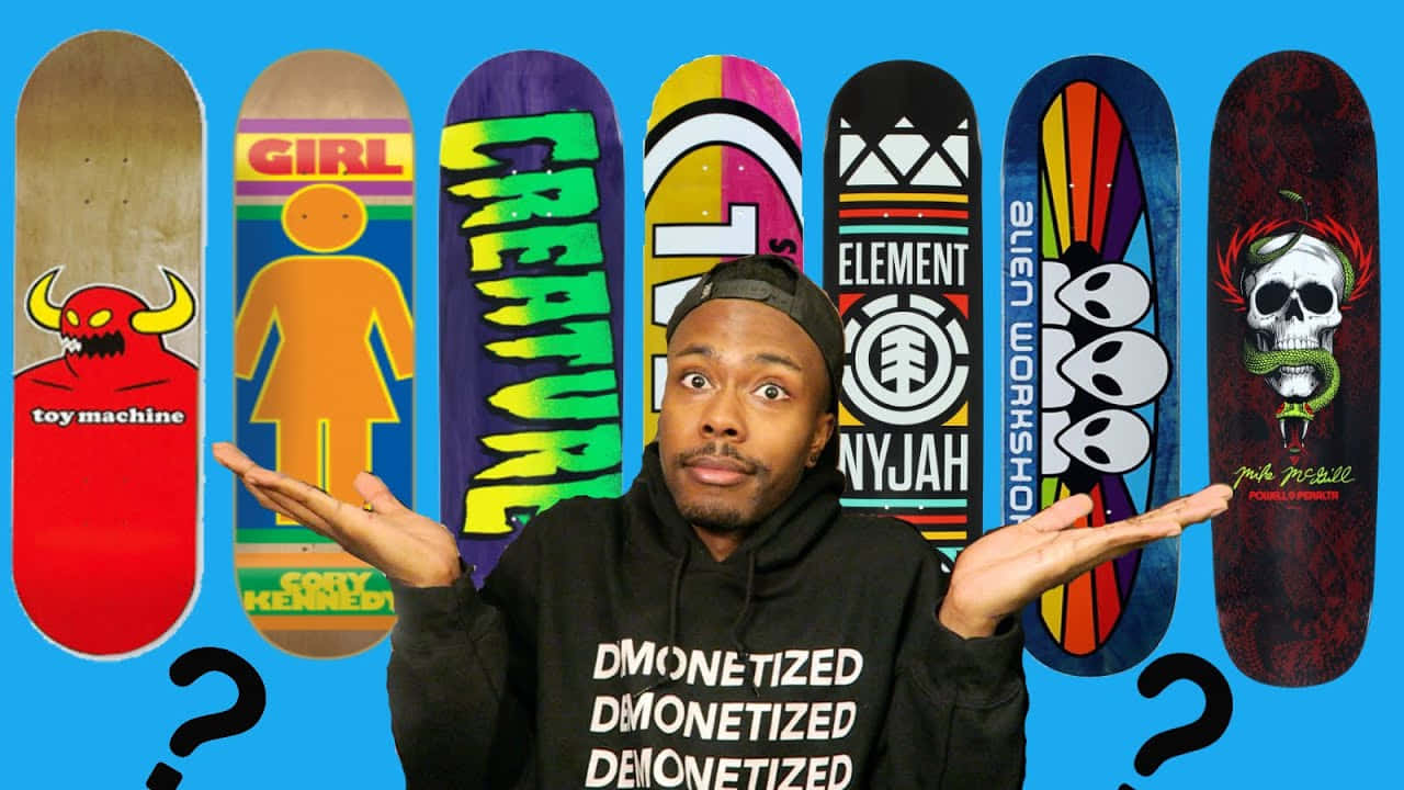 A Man Is Holding A Skateboard With Different Designs Background
