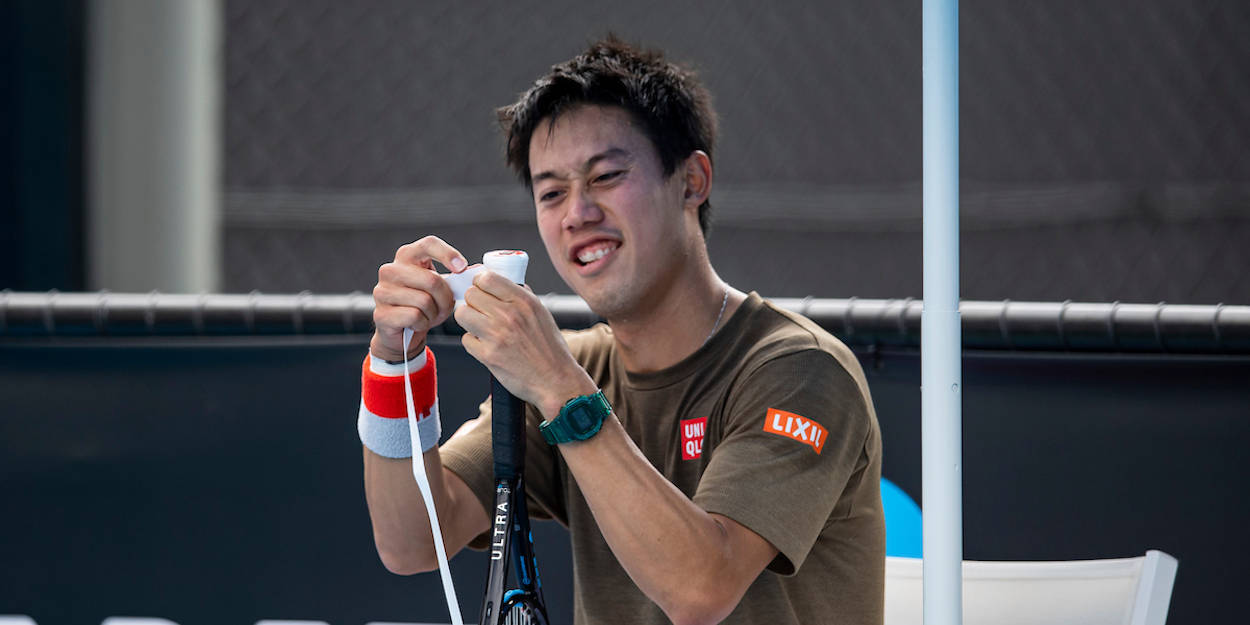 A Man Is Holding A Tennis Racket