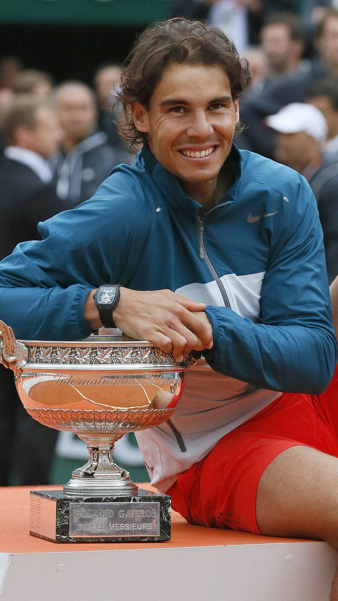 A Man Is Holding A Trophy