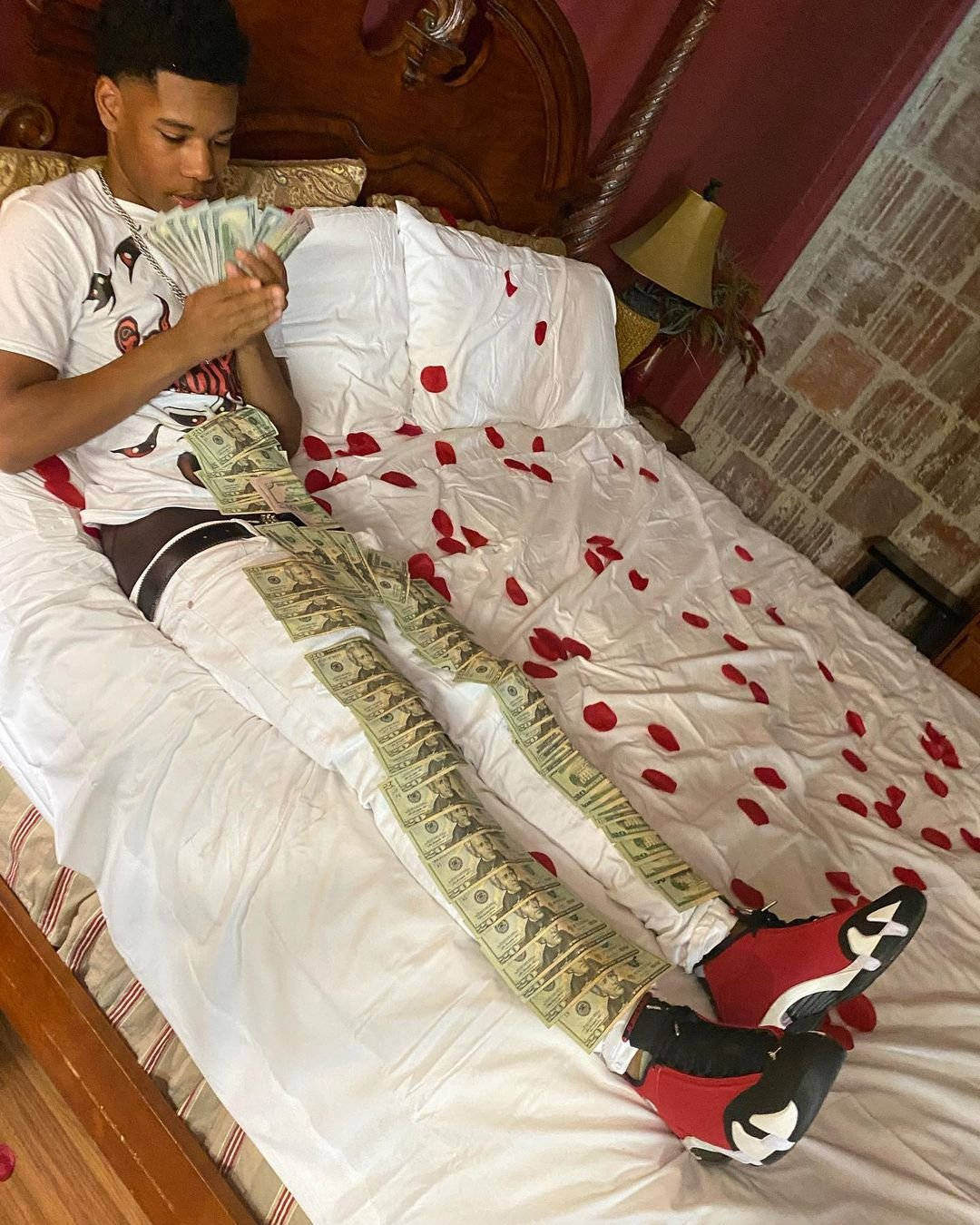 A Man Is Laying On A Bed With Money On His Bed Background