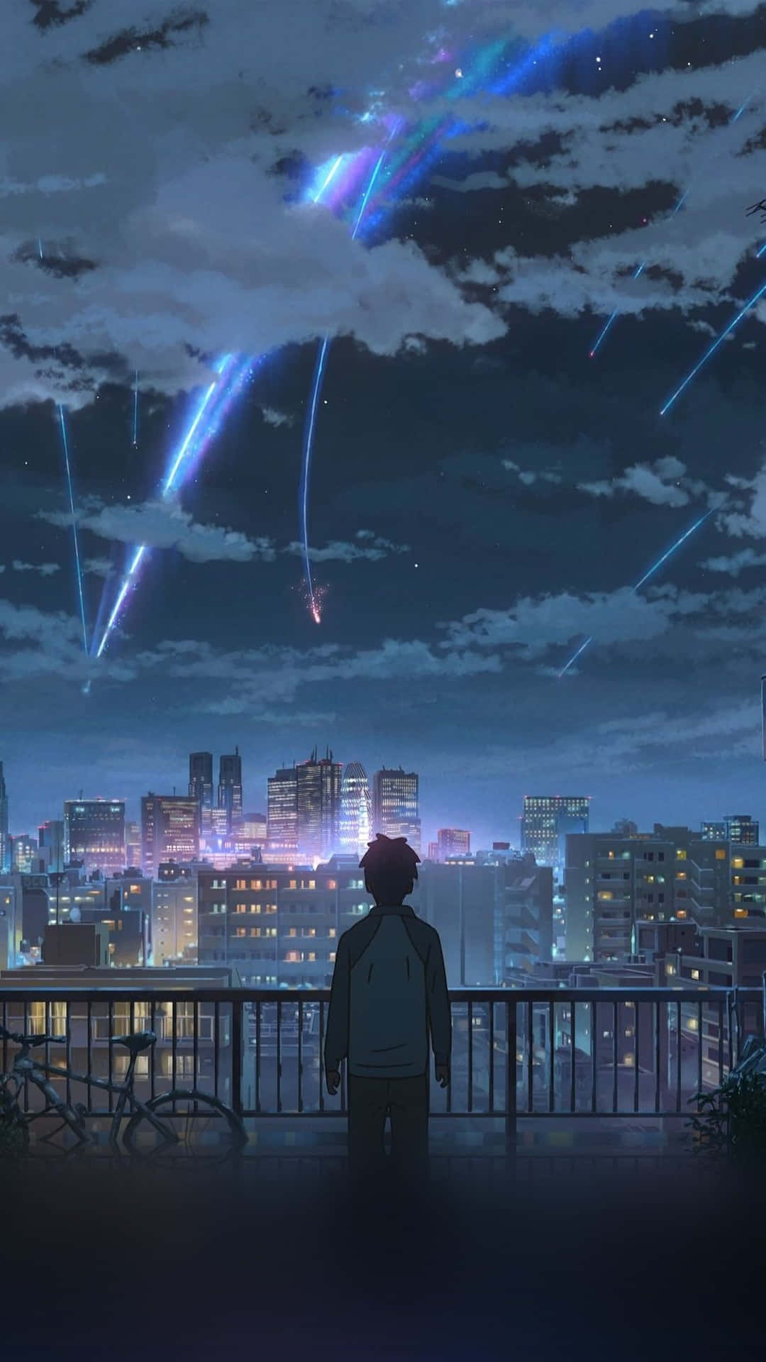 A Man Is Looking Out Over A City At Night