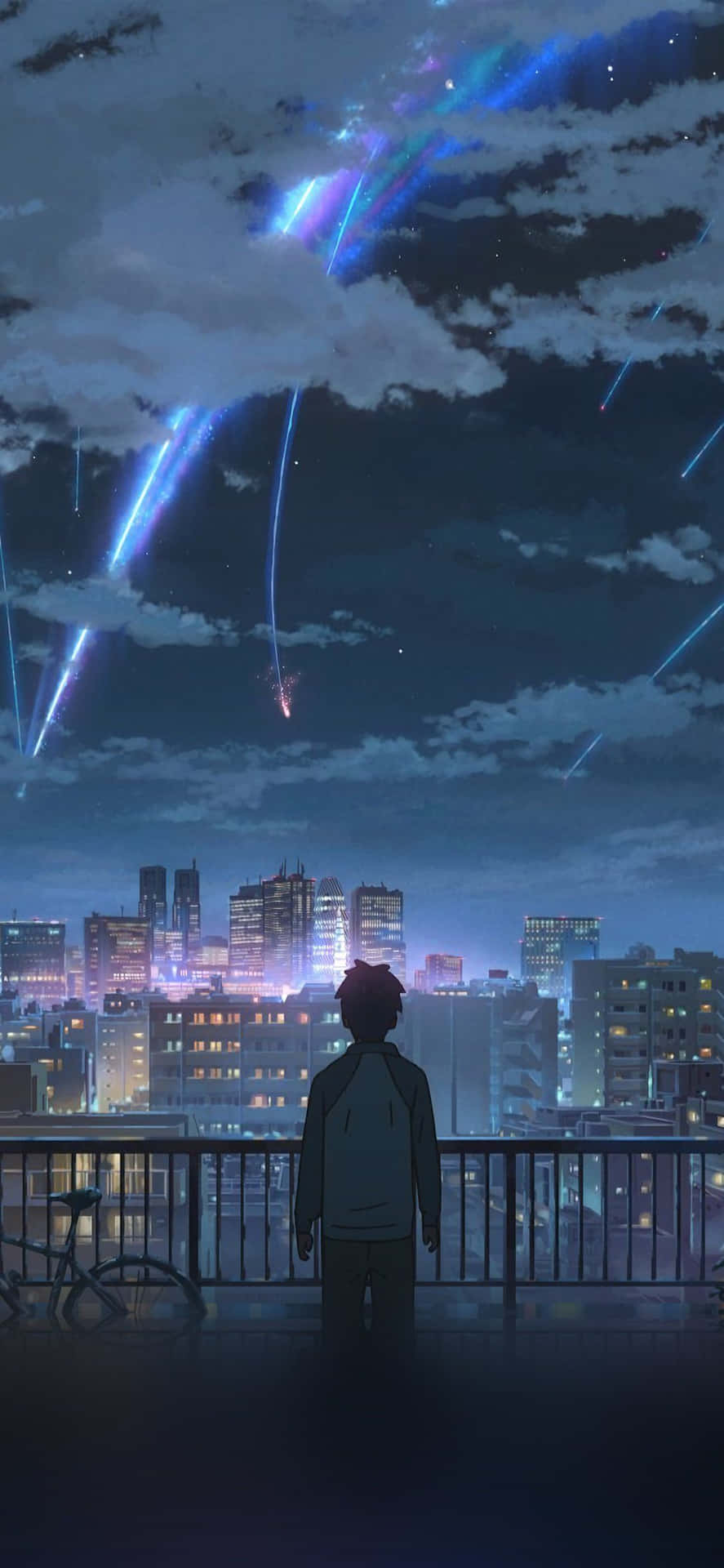 A Man Is Looking Out Over A City At Night