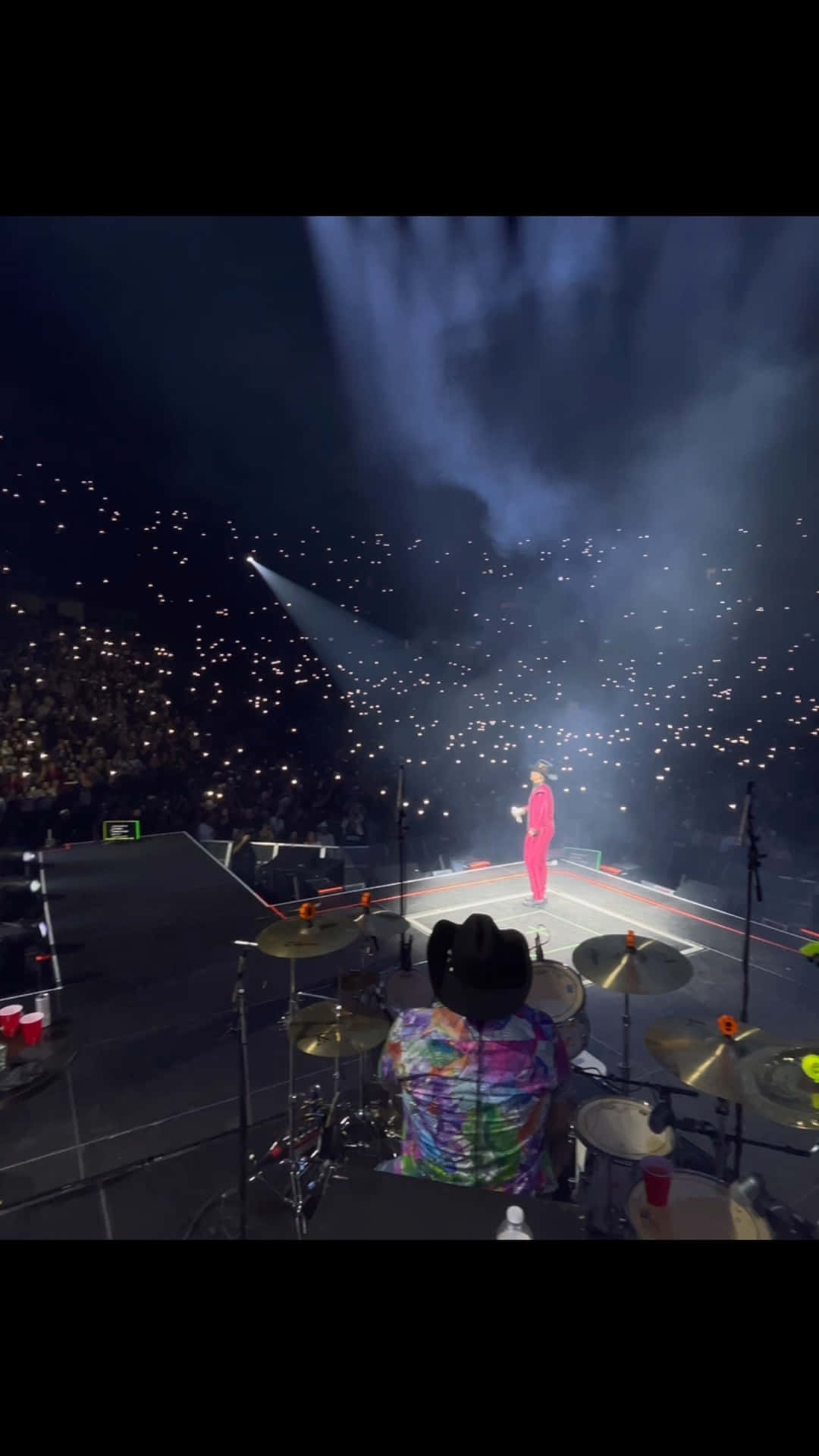 A Man Is Playing Drums In A Concert Background