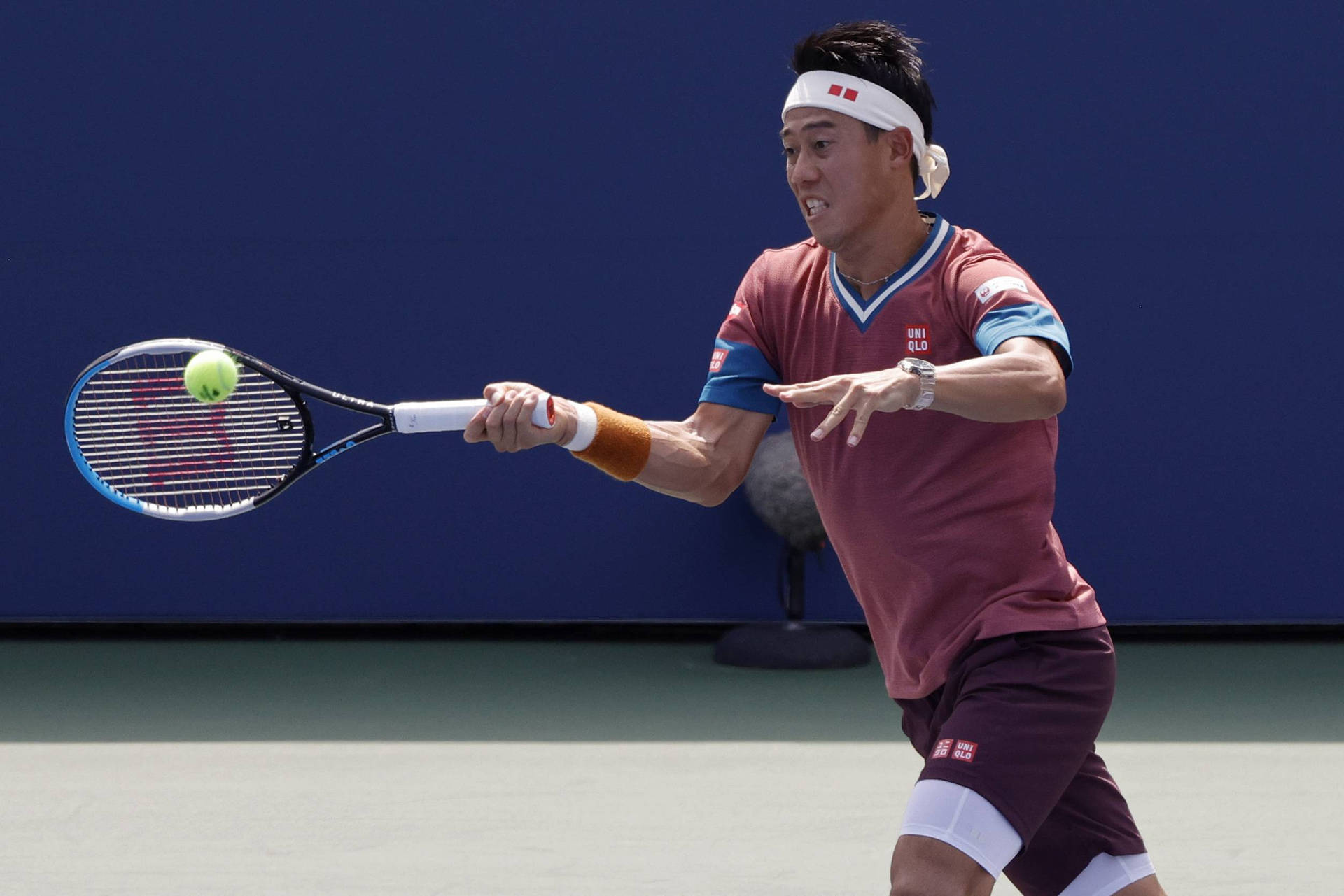 A Man Is Playing Tennis On A Court