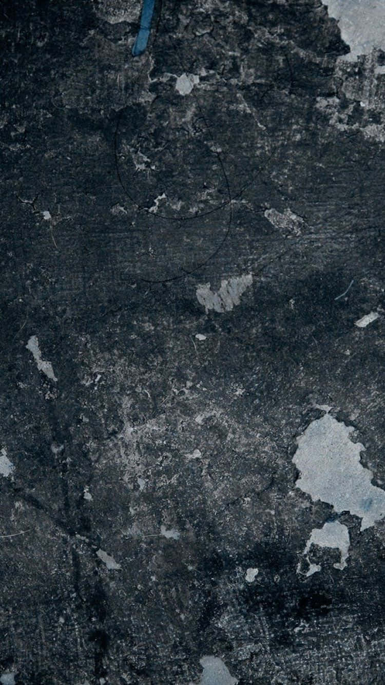 A Man Is Riding A Skateboard On A Concrete Surface Background