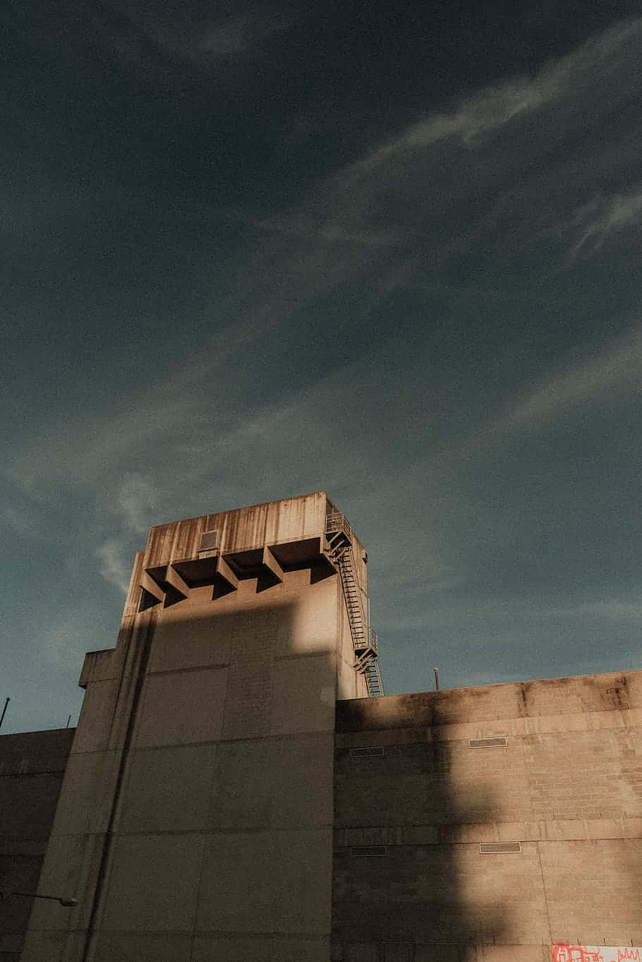 A Man Is Riding A Skateboard On A Concrete Wall Background