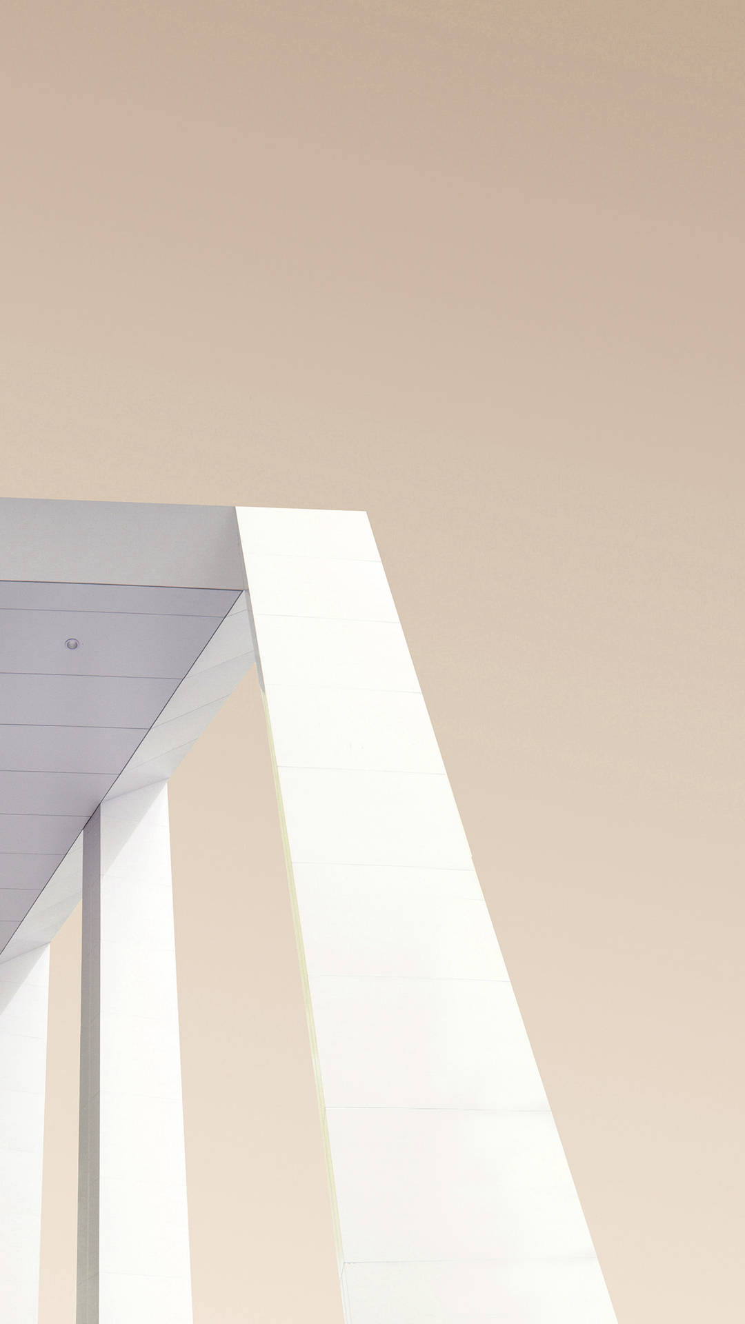 A Man Is Riding A Skateboard On A White Building