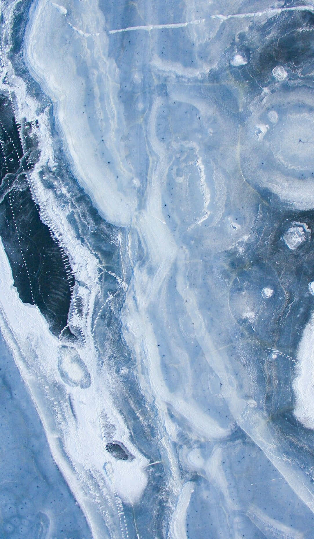 A Man Is Skiing On A Frozen Lake Background