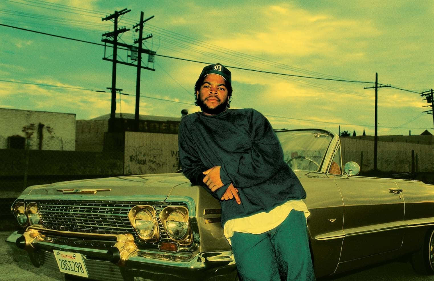 A Man Is Standing Next To A Classic Car Background