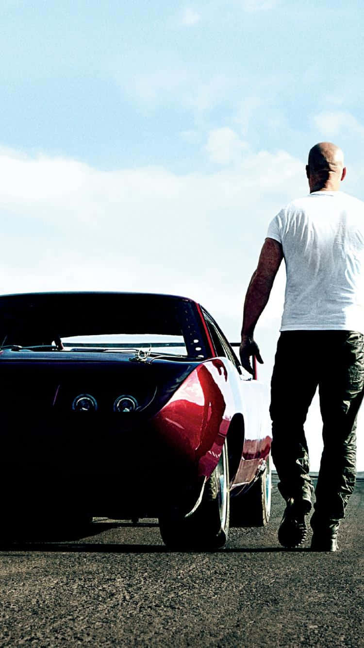 A Man Is Standing Next To A Red Car Background