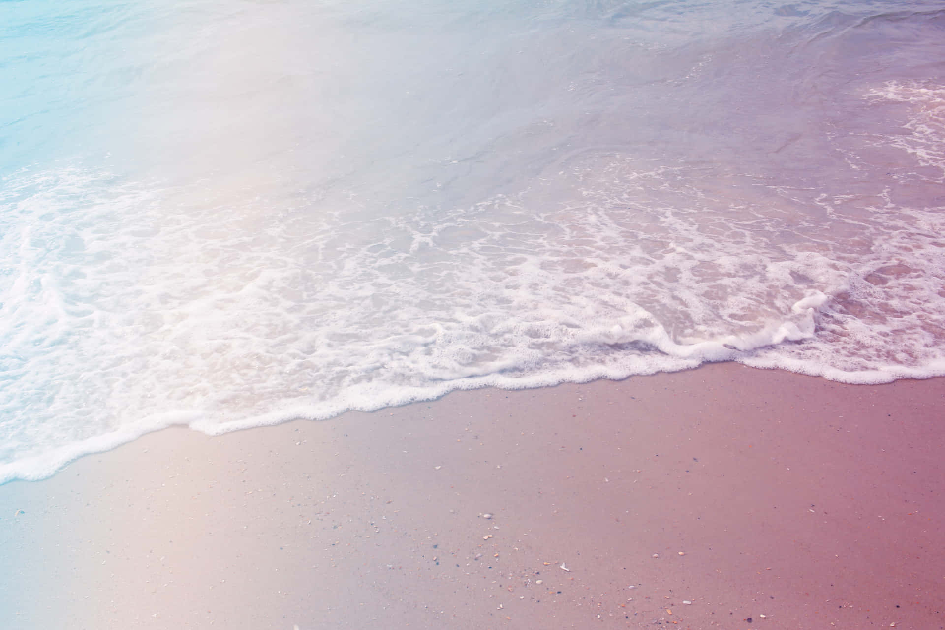 A Man Is Standing On A Beach With A Surfboard Background