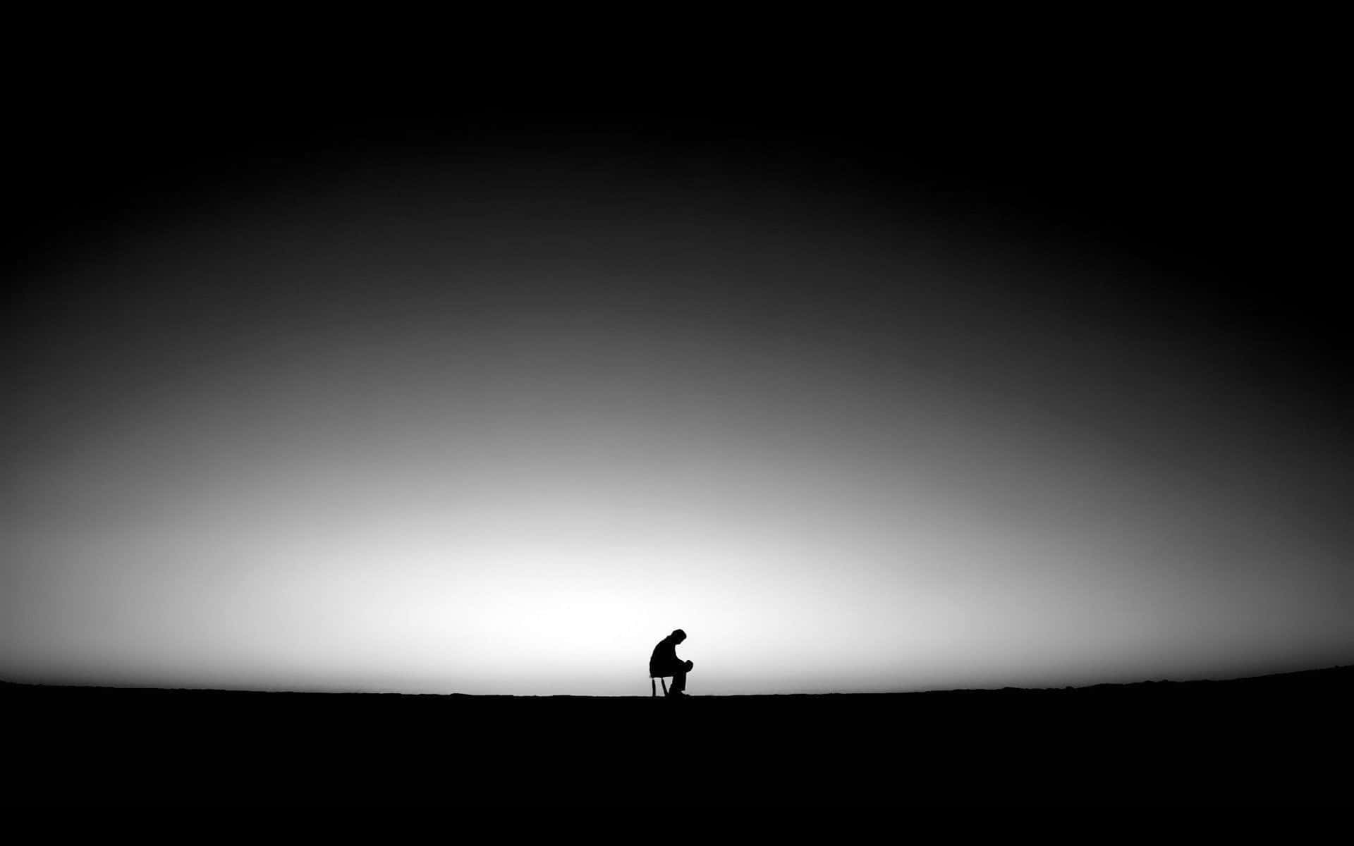 A Man Is Standing On A Hill In The Dark