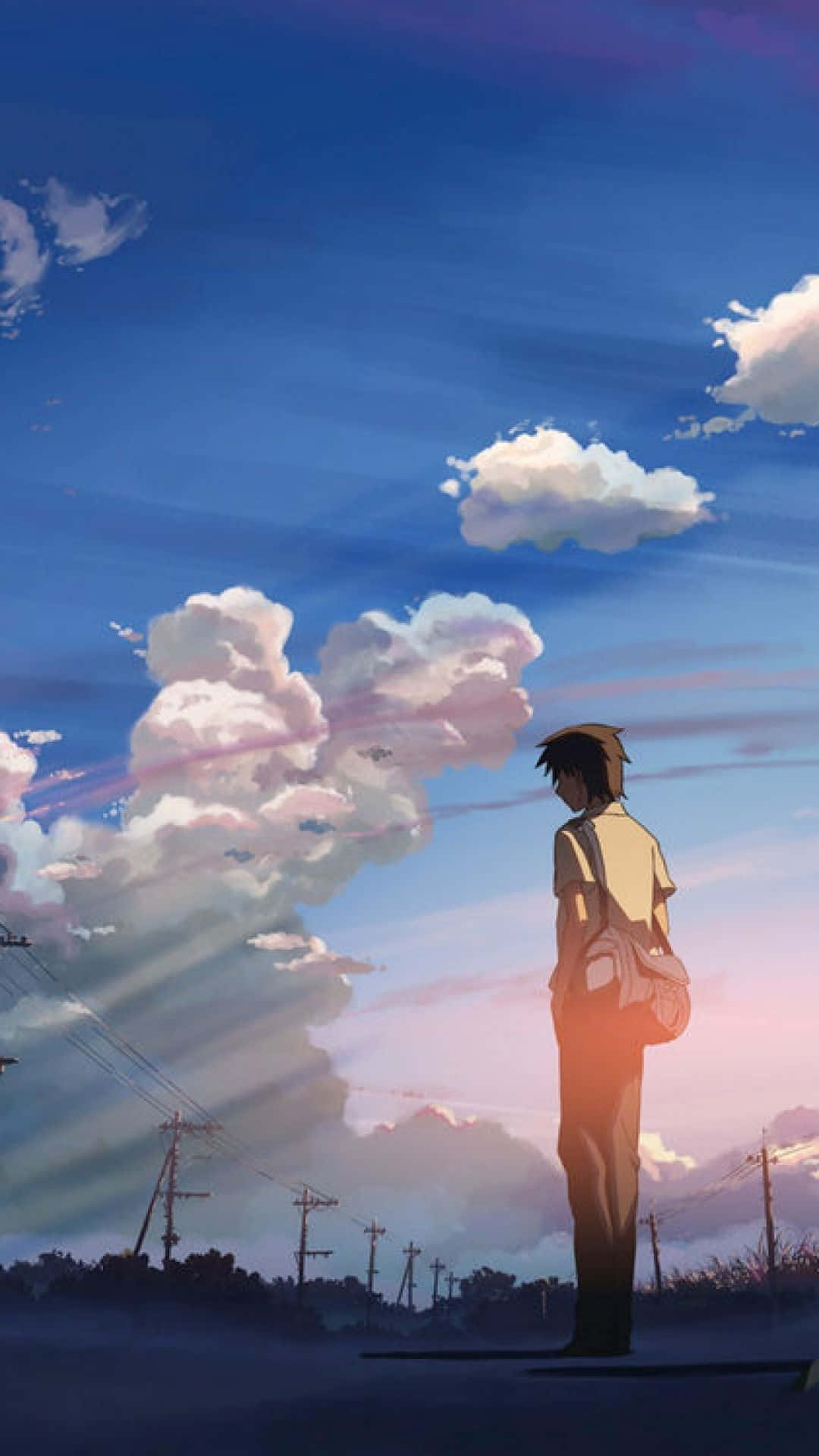 A Man Is Standing On A Road With Clouds In The Background Background