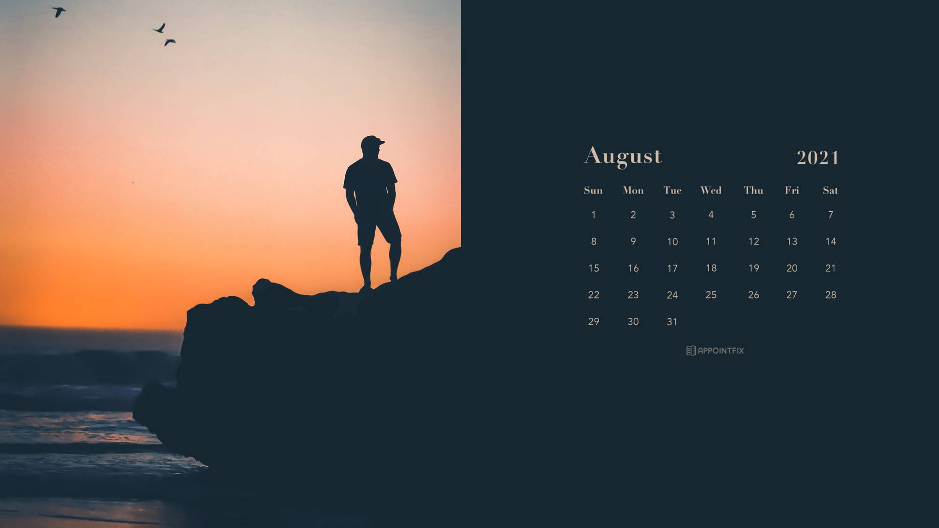 A Man Is Standing On A Rock At Sunset