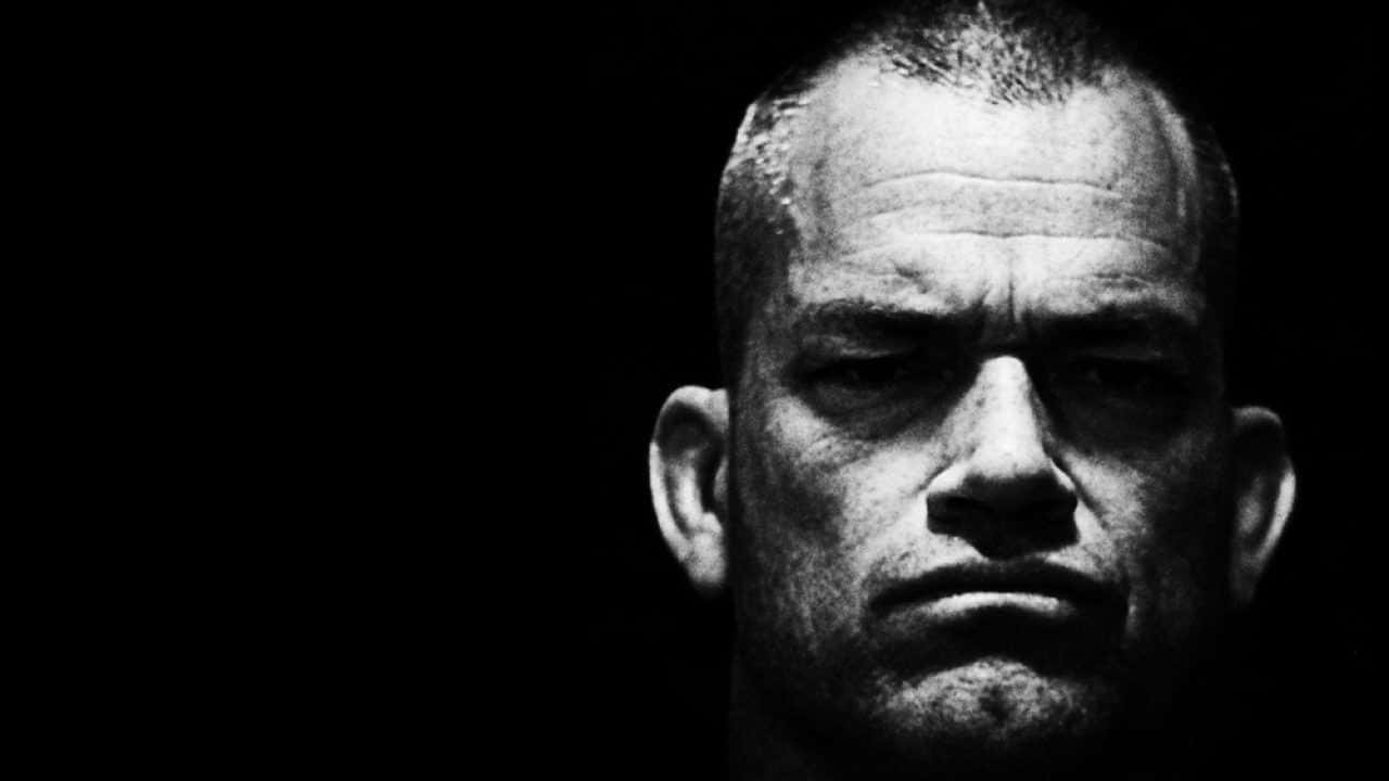 A Man Is Staring At The Camera In Black And White Background