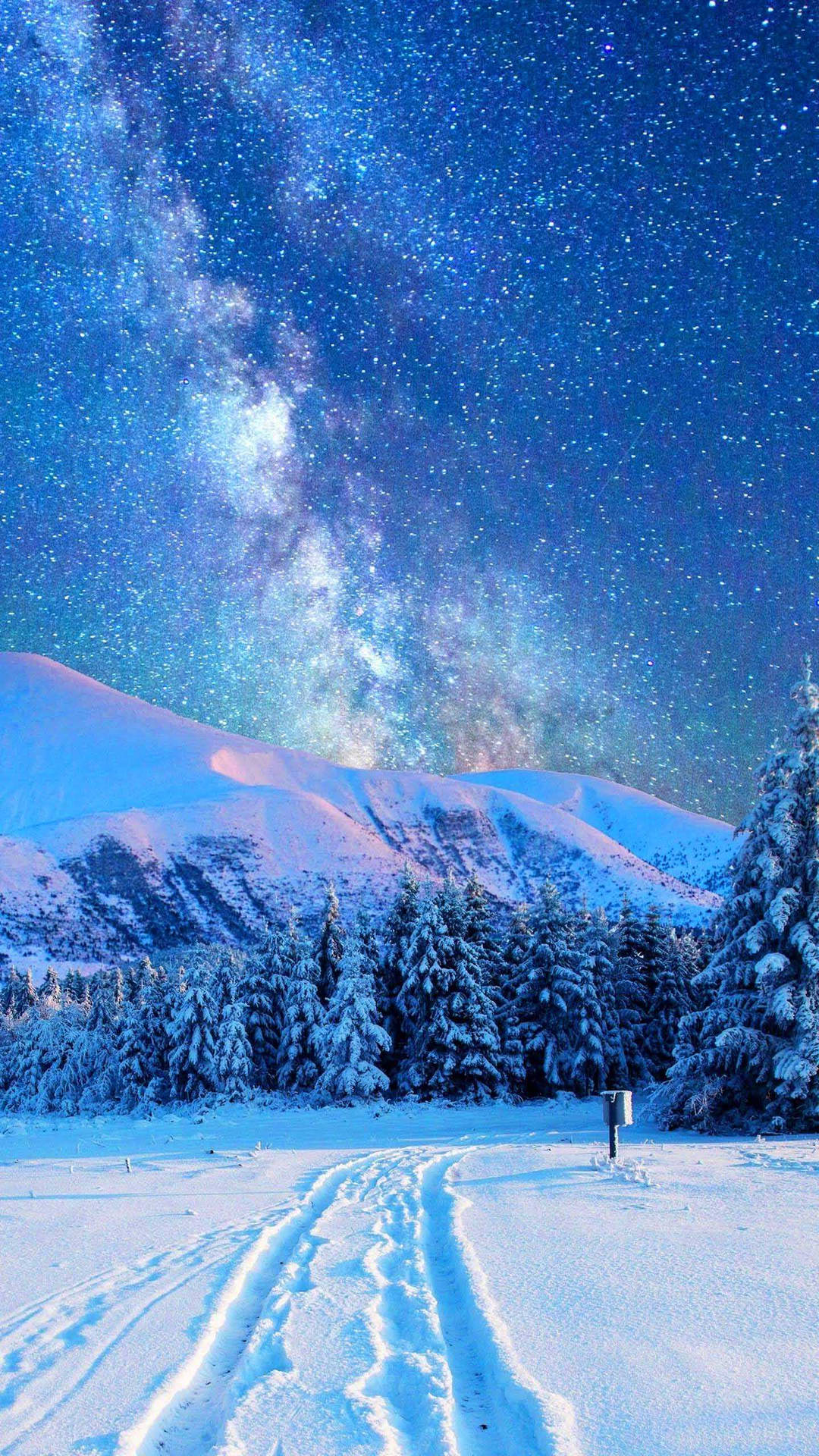 A Man Is Walking Through The Snow Under The Milky Background