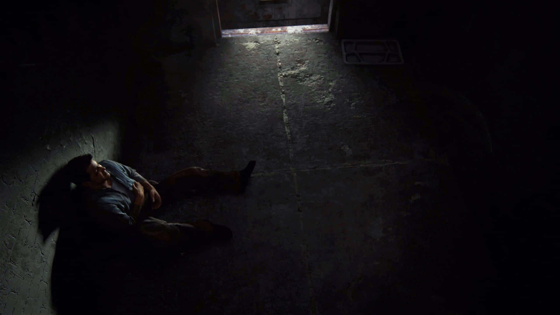 A Man Laying On The Floor In A Dark Room Background