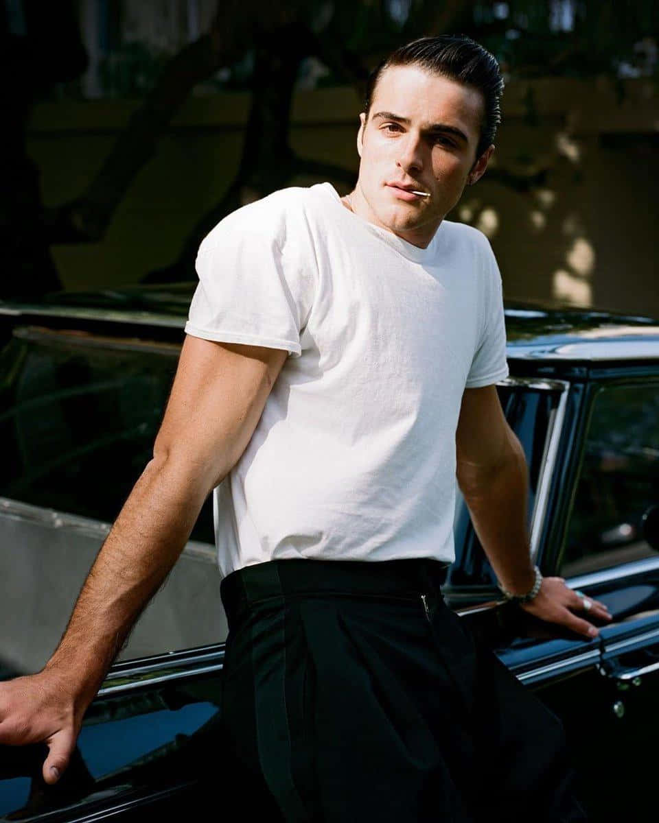 A Man Leaning Against A Car Background