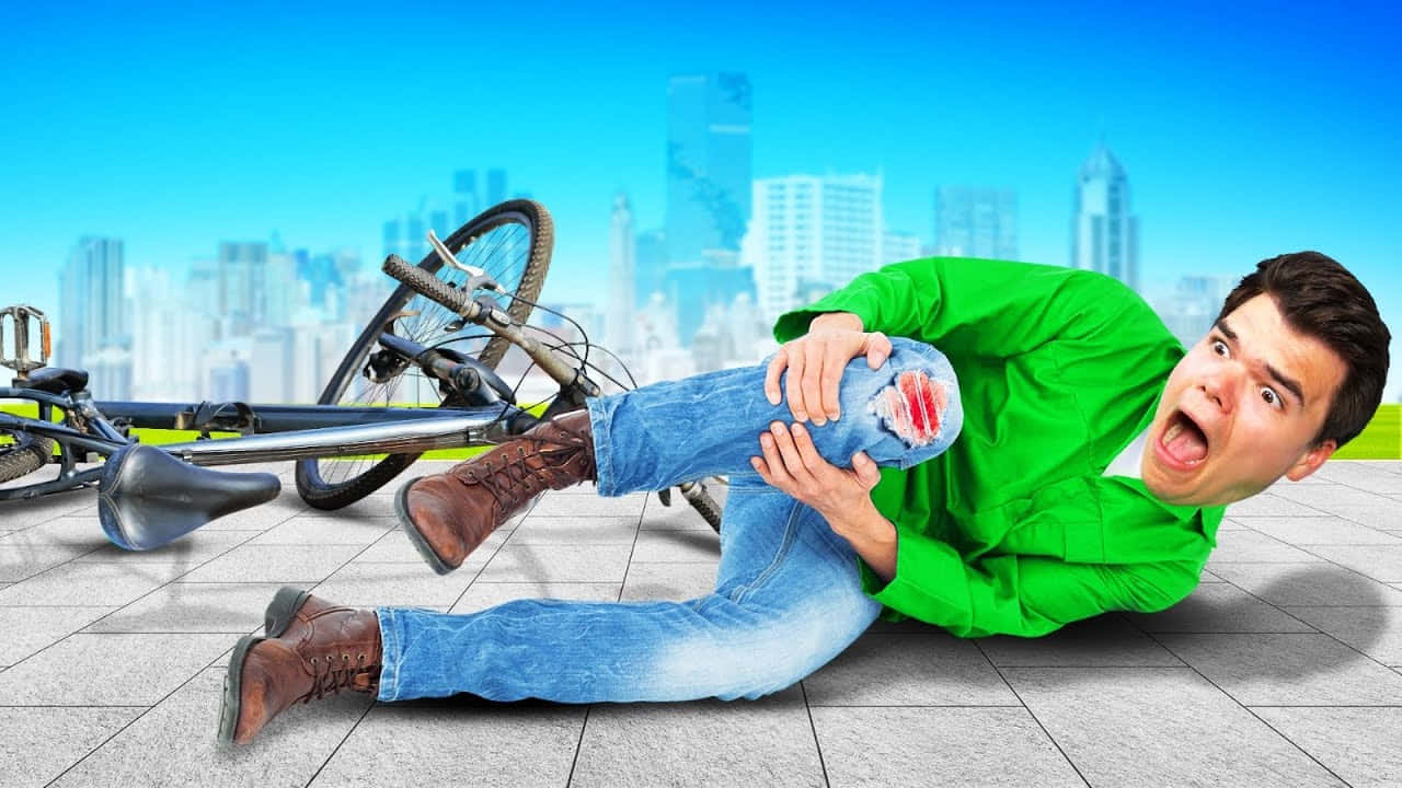 A Man Lying On The Ground With His Bicycle Background