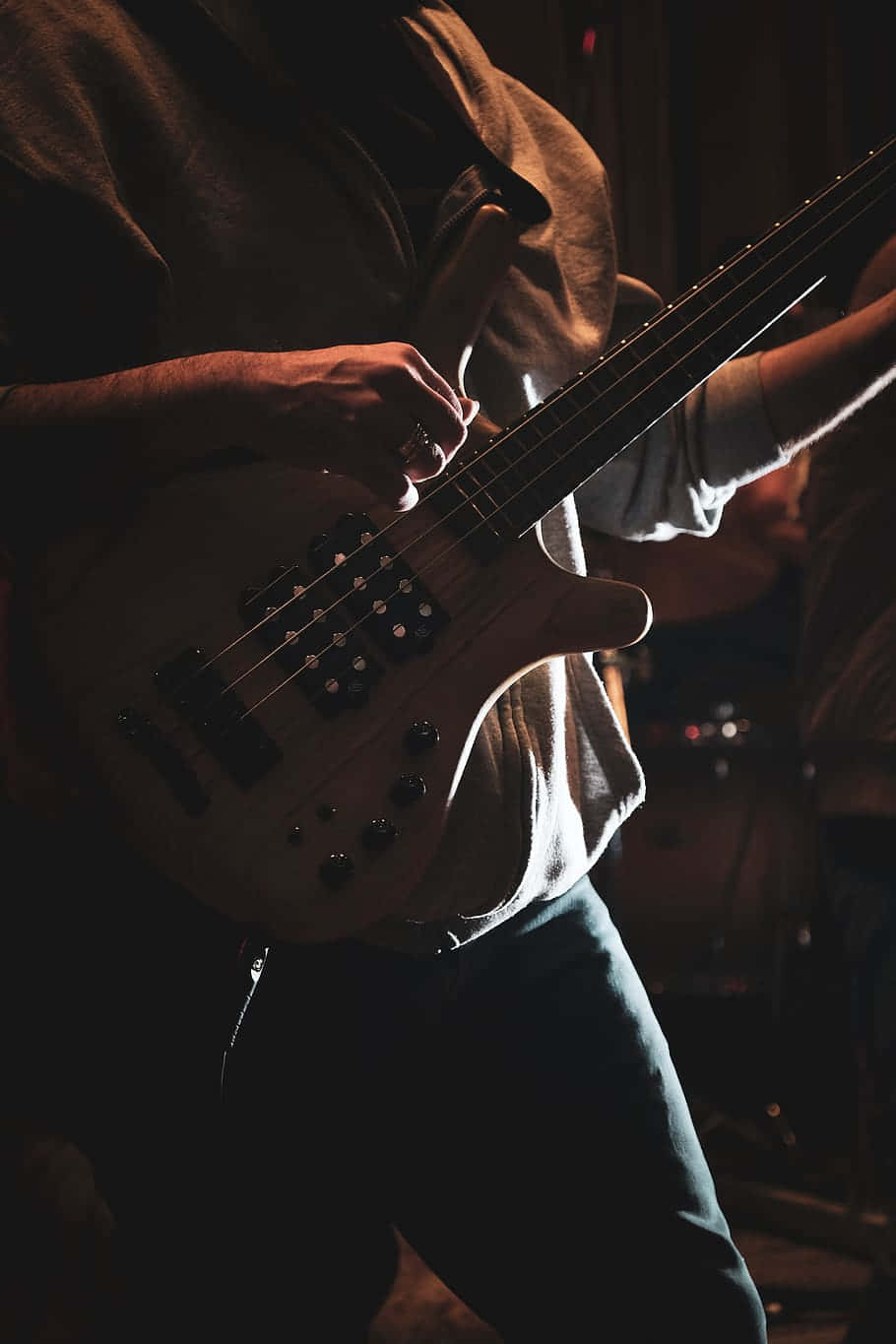 A Man Playing A Bass Guitar