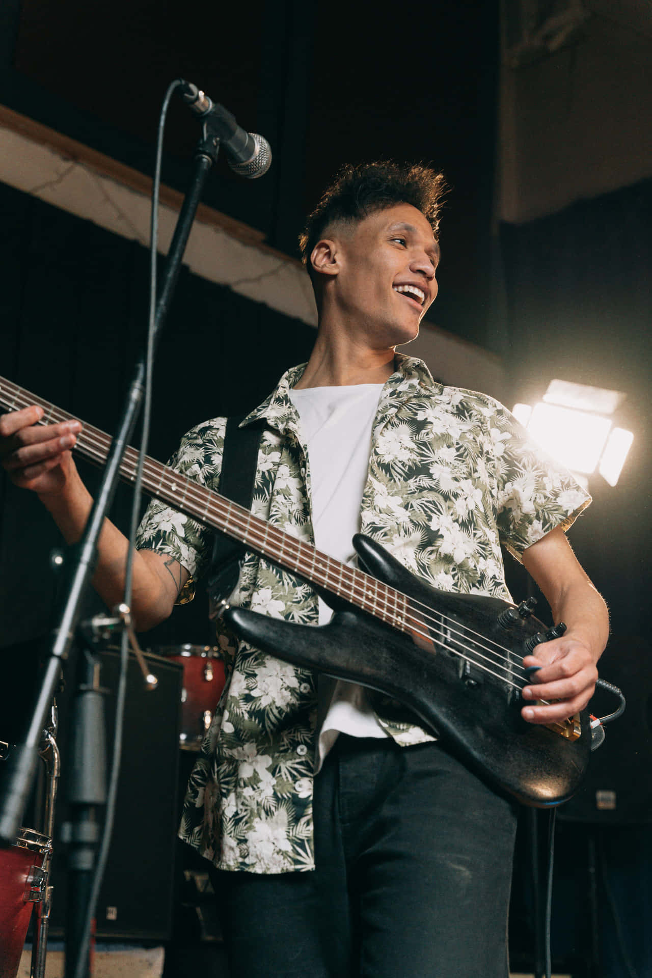 A Man Playing A Guitar In A Recording Studio