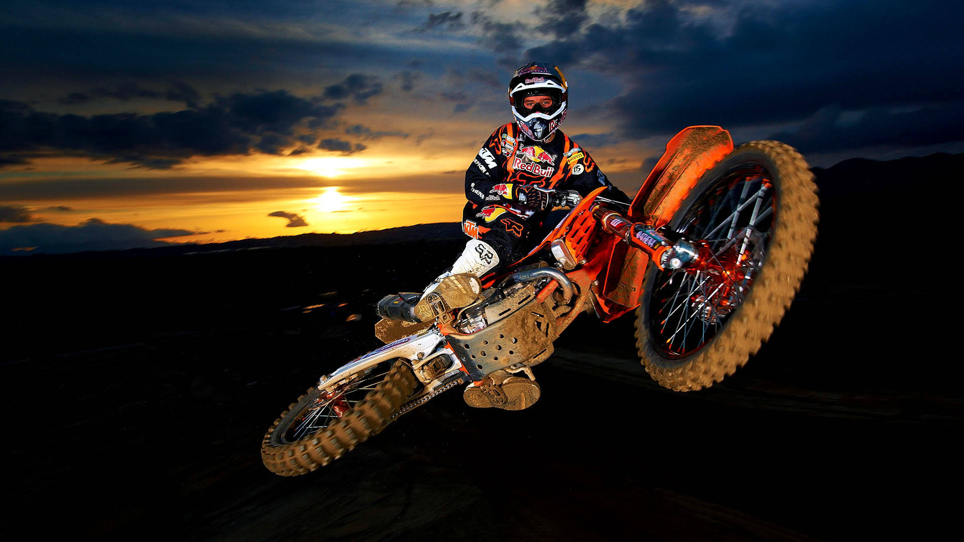 A Man Riding A Dirt Bike Background