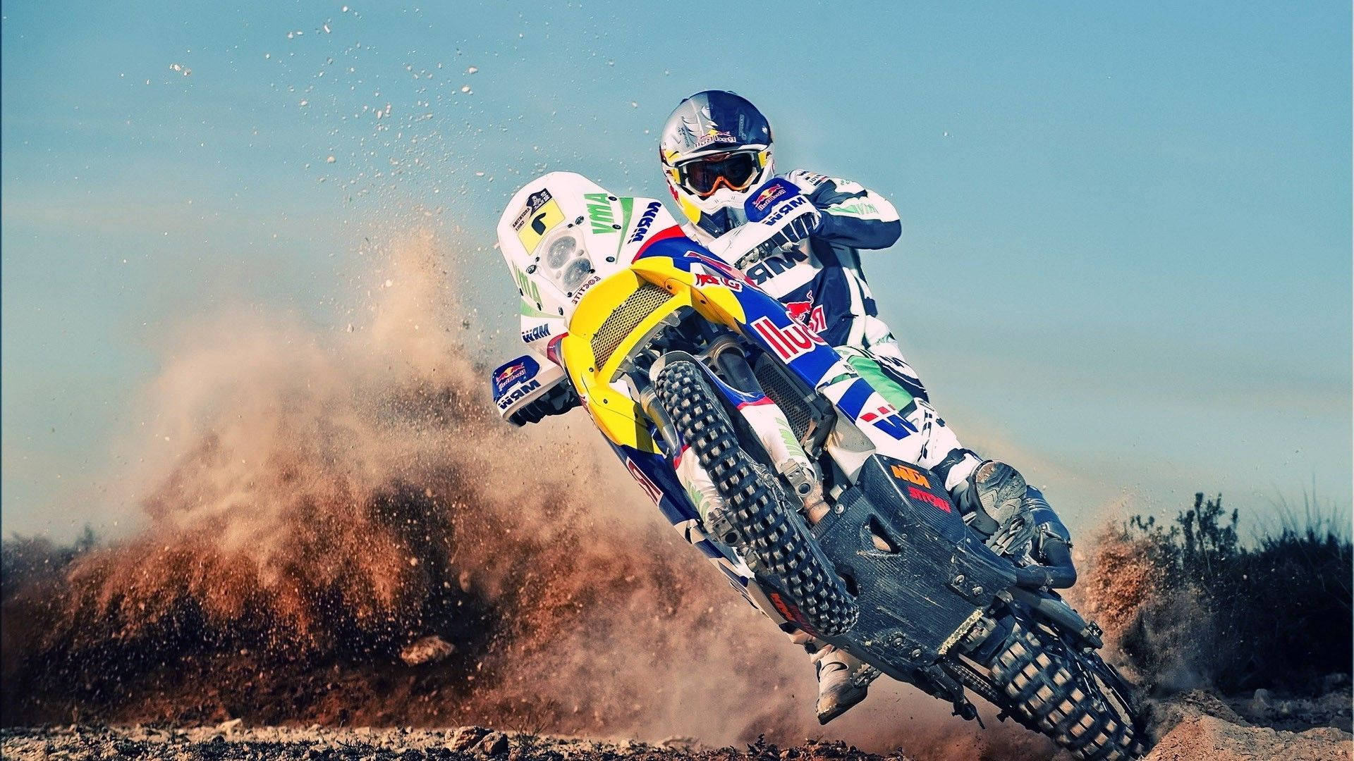 A Man Riding A Dirt Bike On A Dirt Track Background